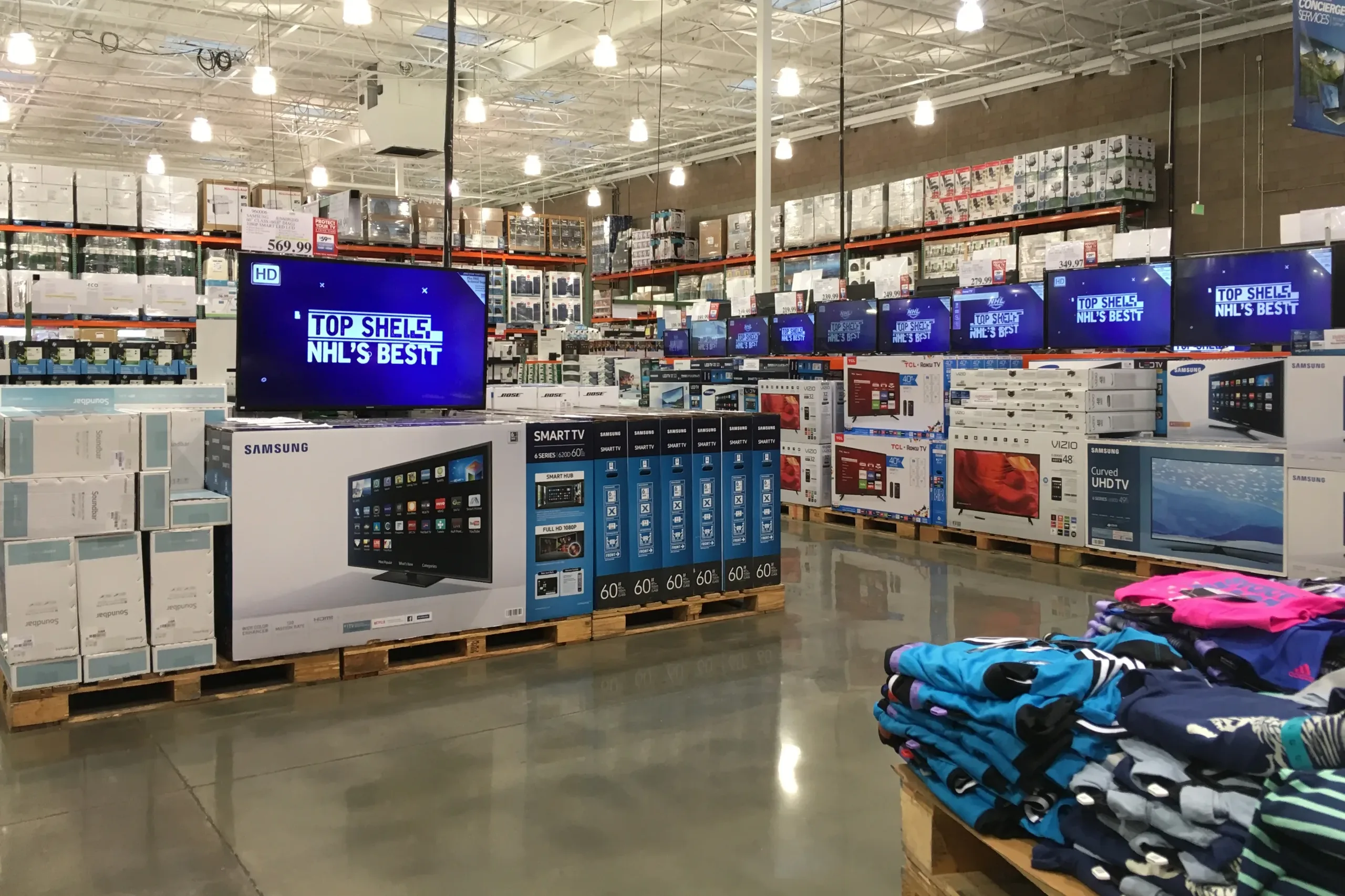 Televisions and merchandise on pallets inside a Costco warehouse