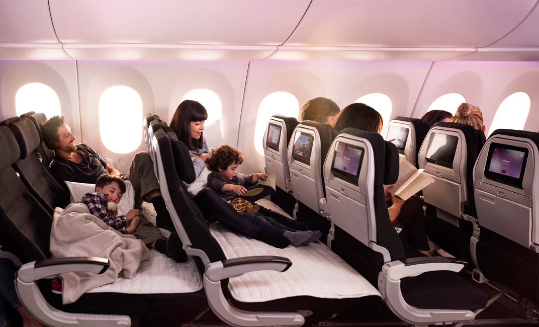 Air New Zealand Skycouch in use with families and children resting on the flat surface