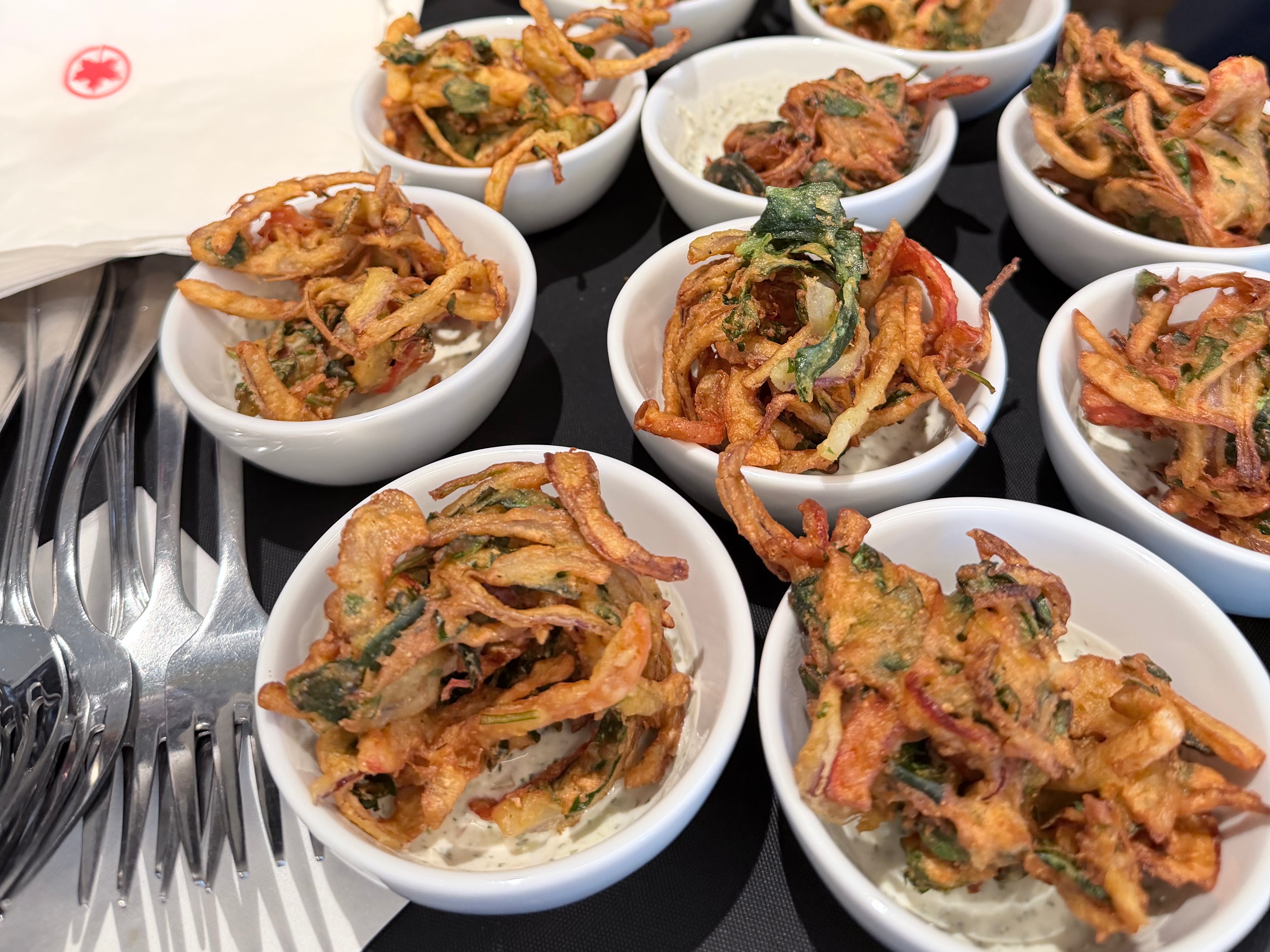 Vegetable pakora served in individual bowls at the Air Canada Café YVR opening event