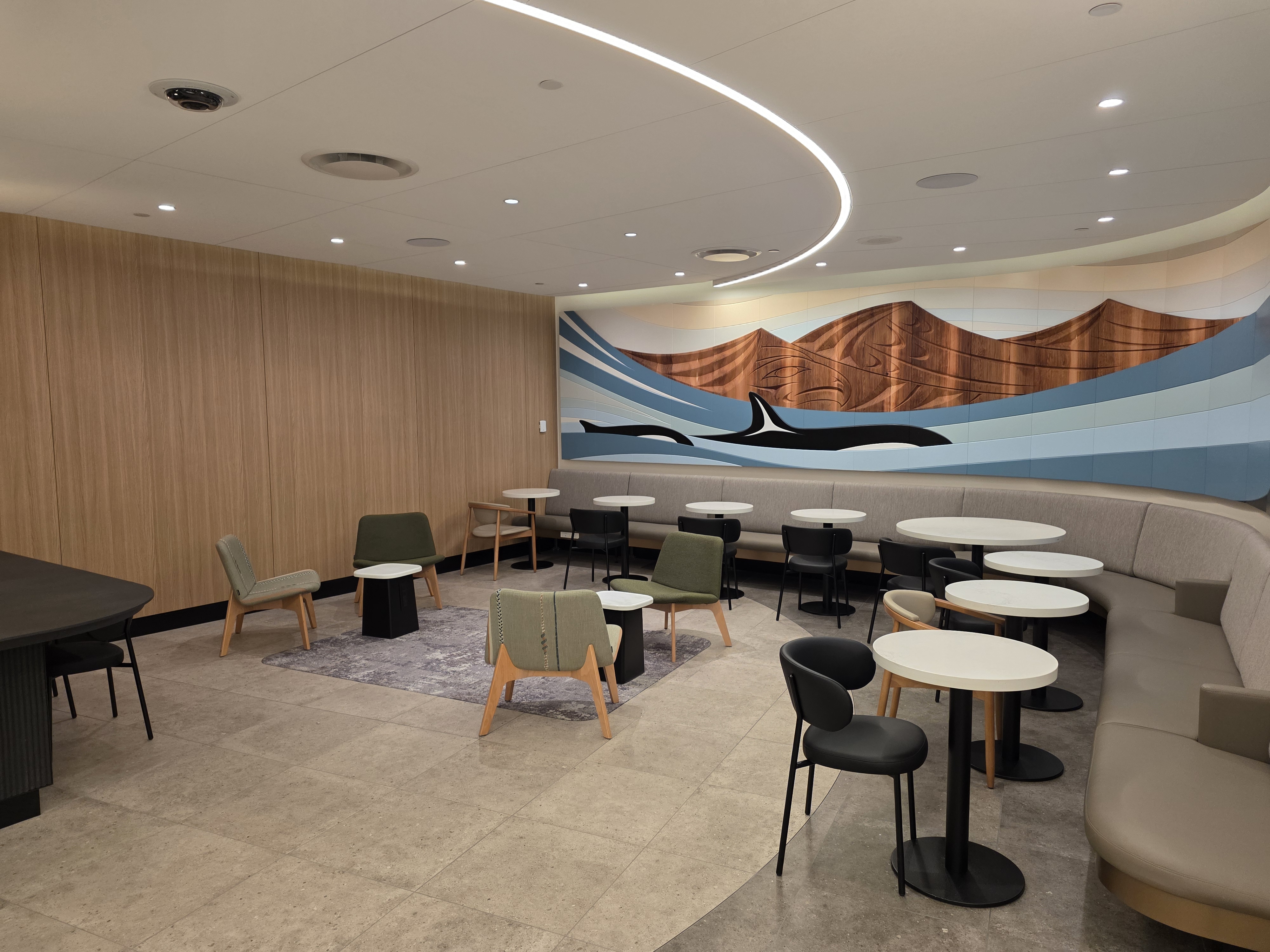 Sea to Sky orca whale art wall by Musqueam artist Kelly Cannell at the Air Canada Café YVR