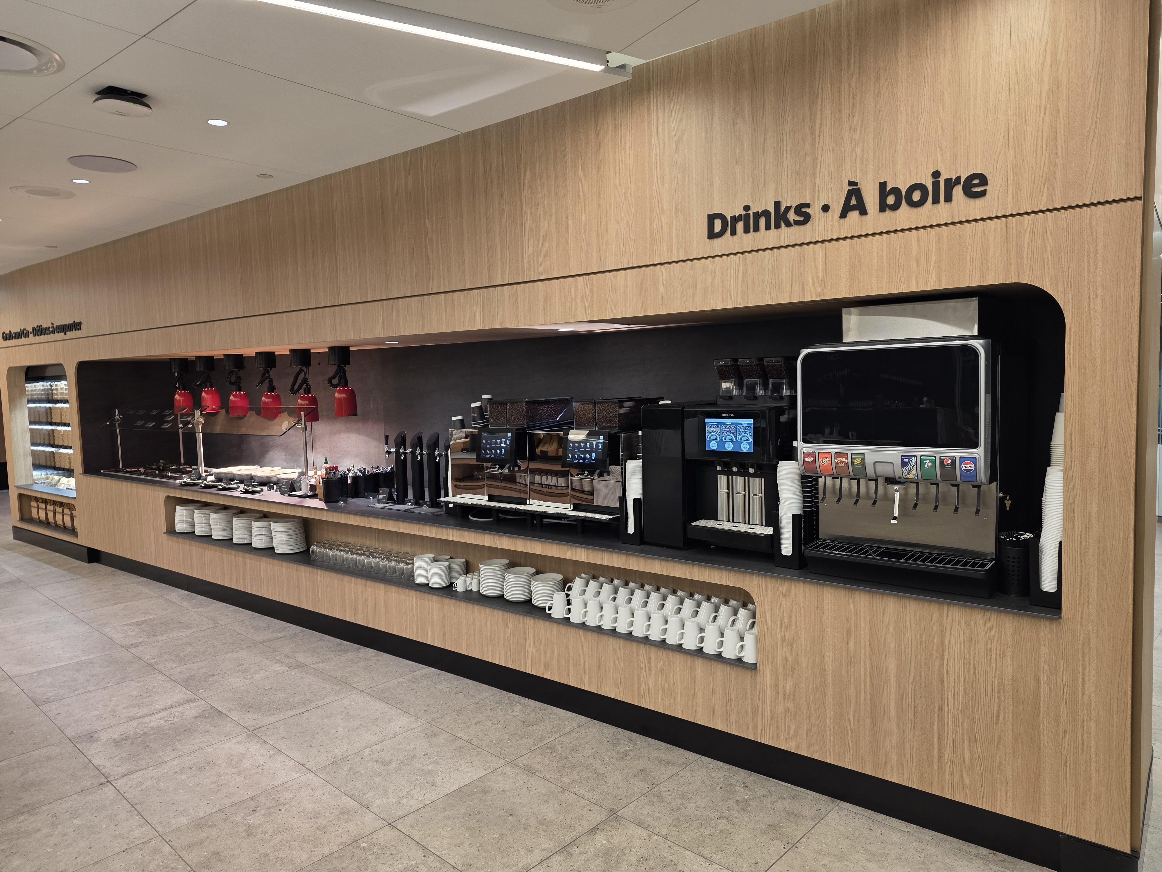 Full drinks station with espresso machines, draft taps, and soft drink dispensers at the Air Canada Café YVR