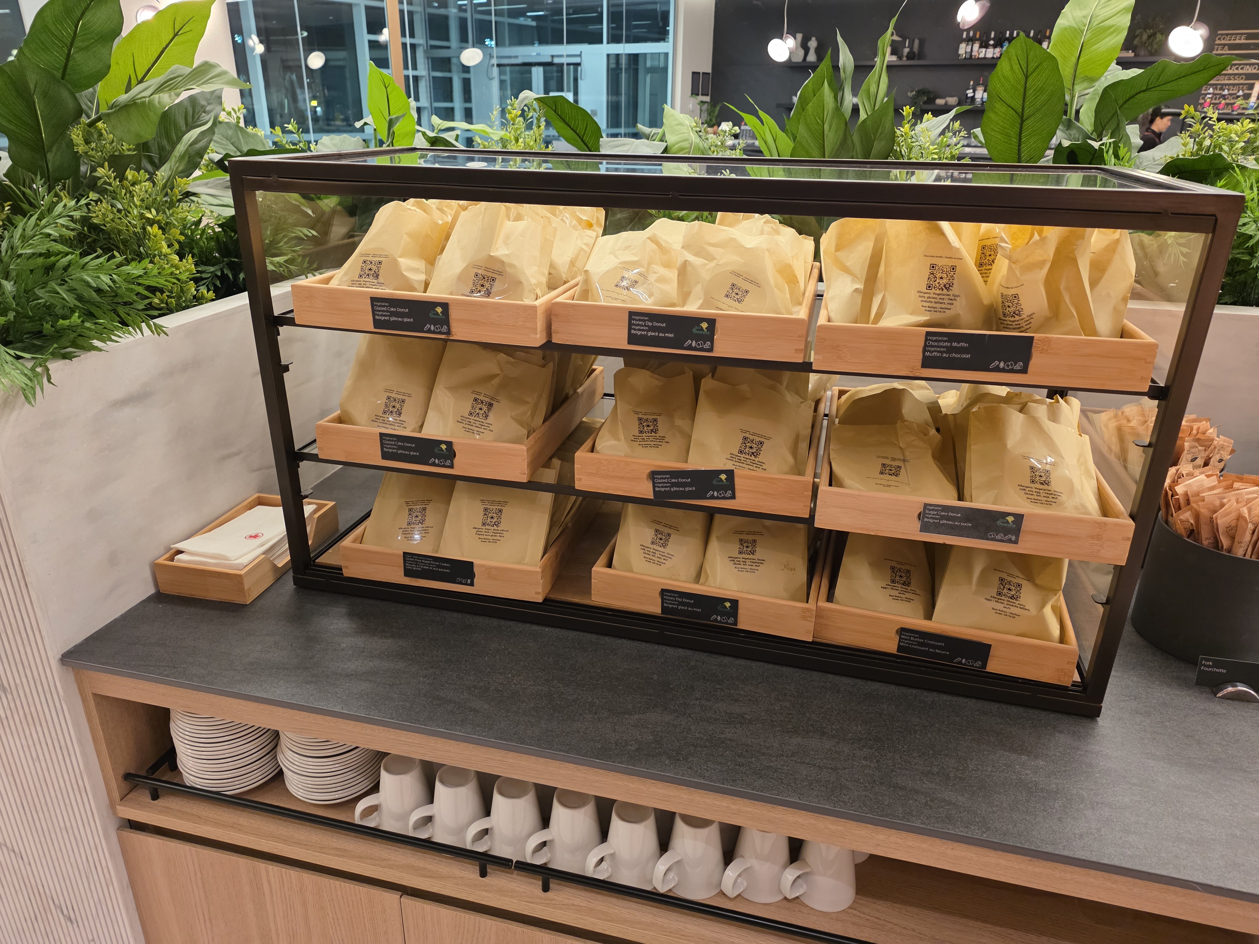 Pre-packed grab-and-go meal bags on display shelves at the Air Canada Café YVR