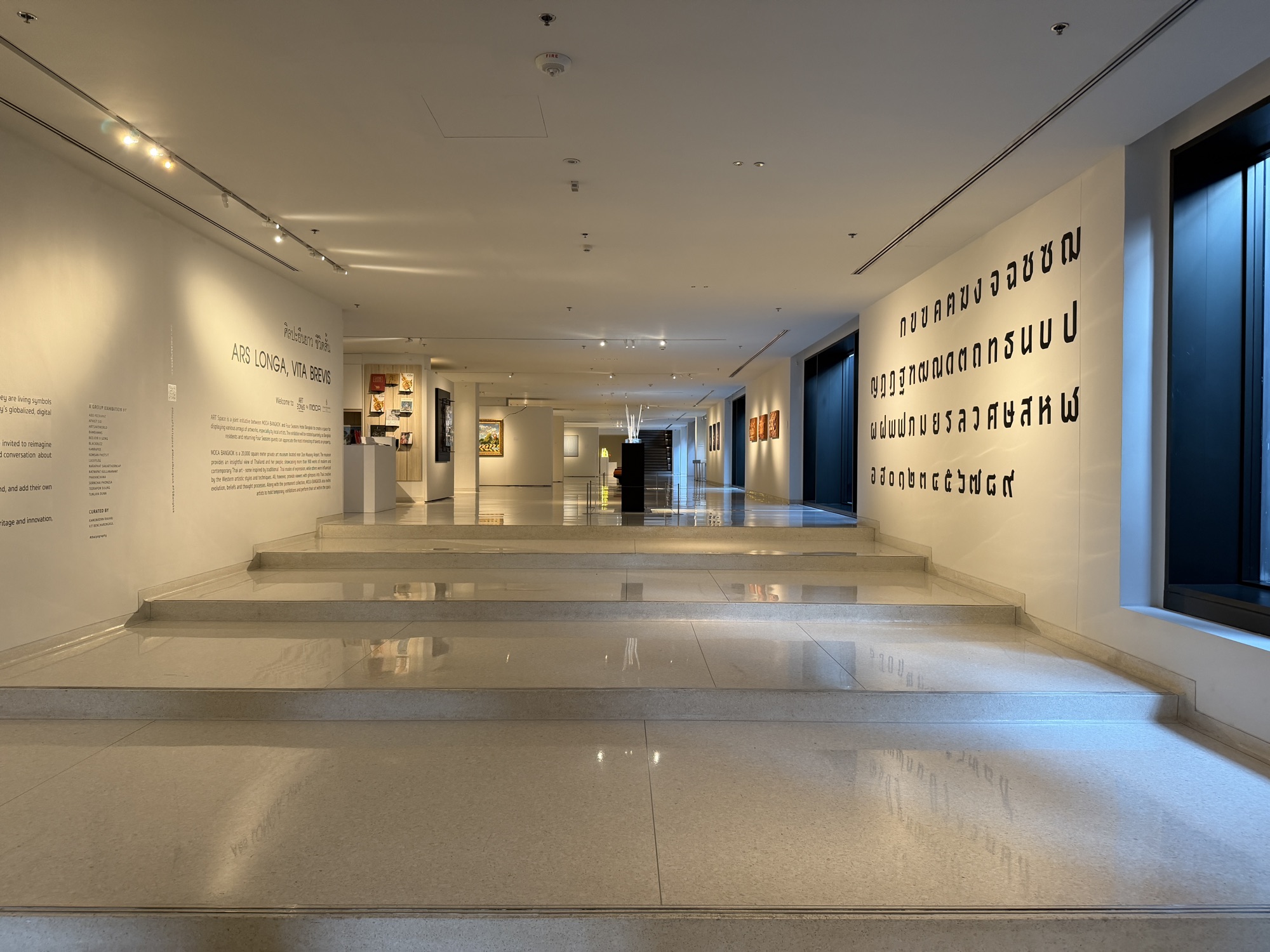 Art gallery corridor stretching the length of the lobby level at Four Seasons Hotel Bangkok at Chao Phraya River