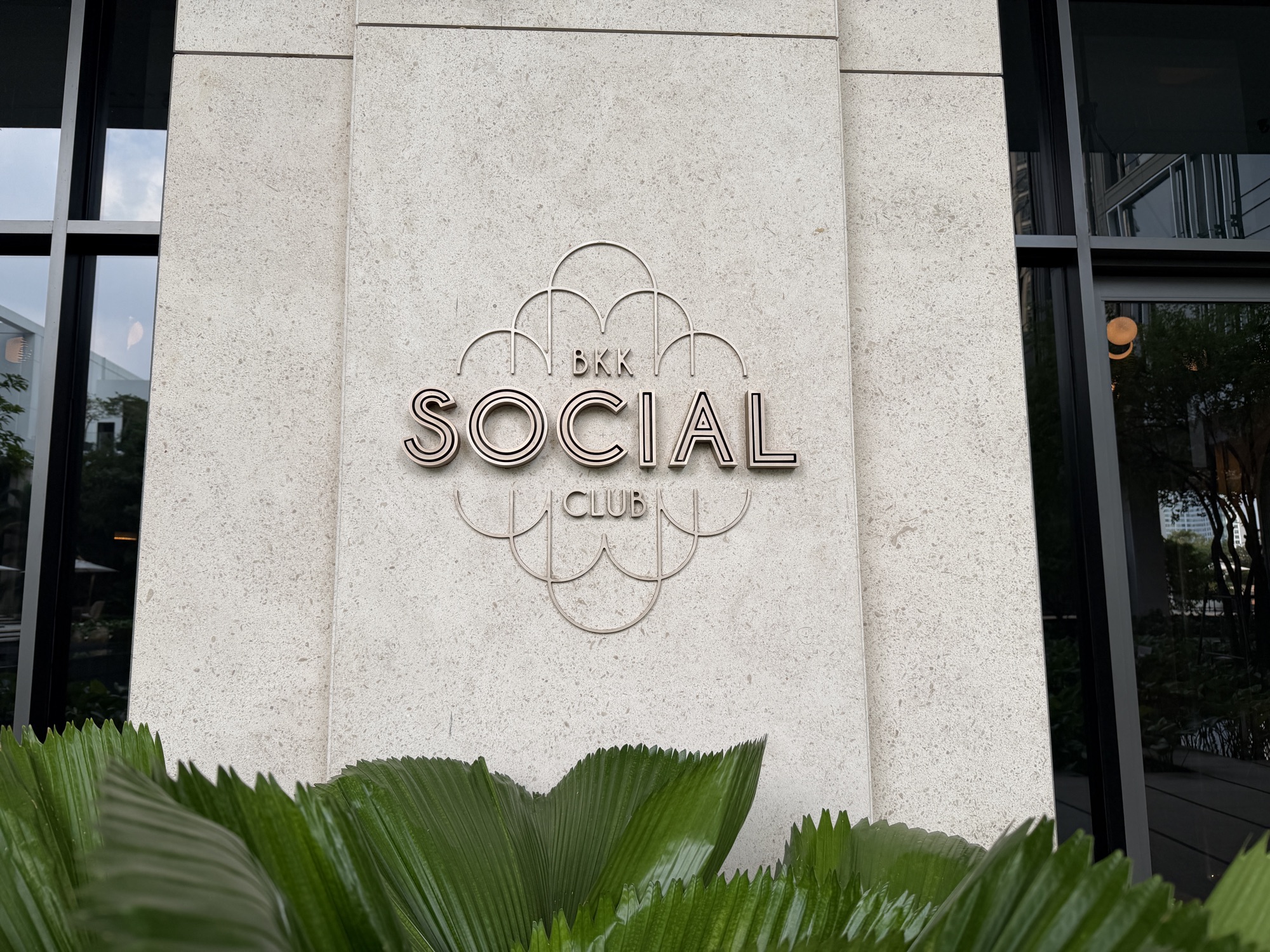 BKK Social Club logo signage on a stone wall at Four Seasons Hotel Bangkok at Chao Phraya River