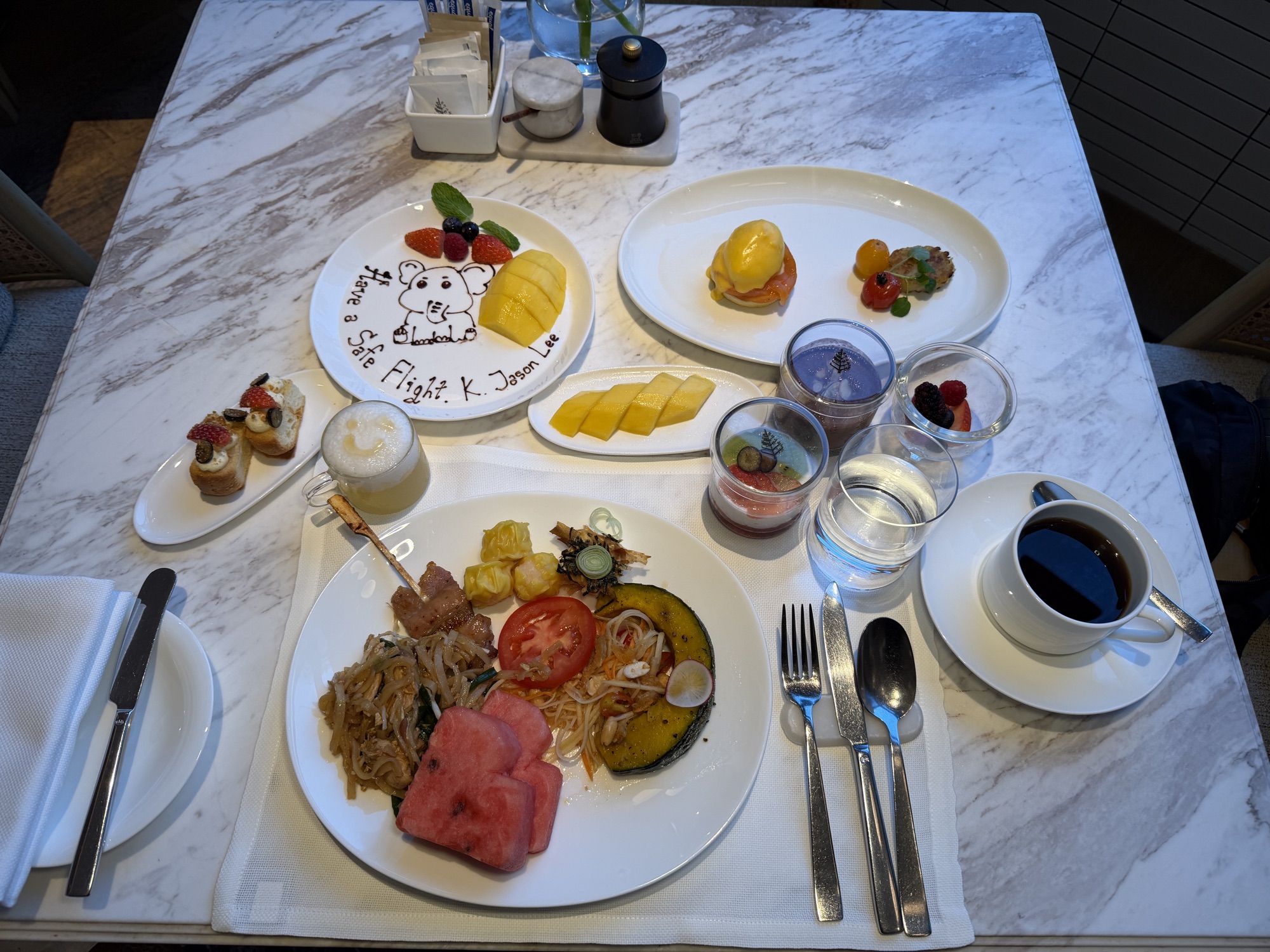 Departure-morning breakfast spread with a personalized elephant plate at Four Seasons Hotel Bangkok at Chao Phraya River