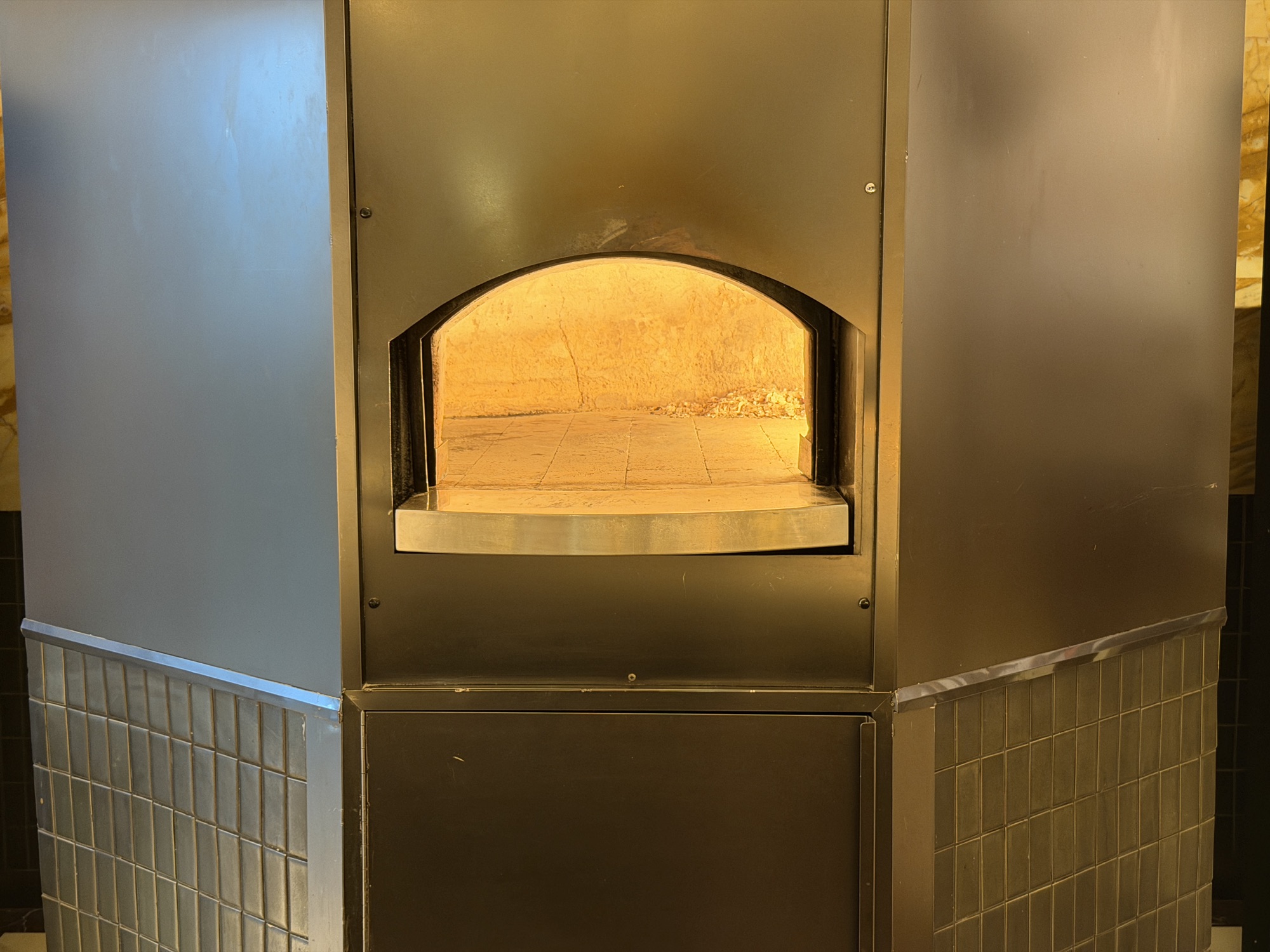 Gold-tiled wood-fired oven at Riva del Fiume at Four Seasons Hotel Bangkok at Chao Phraya River