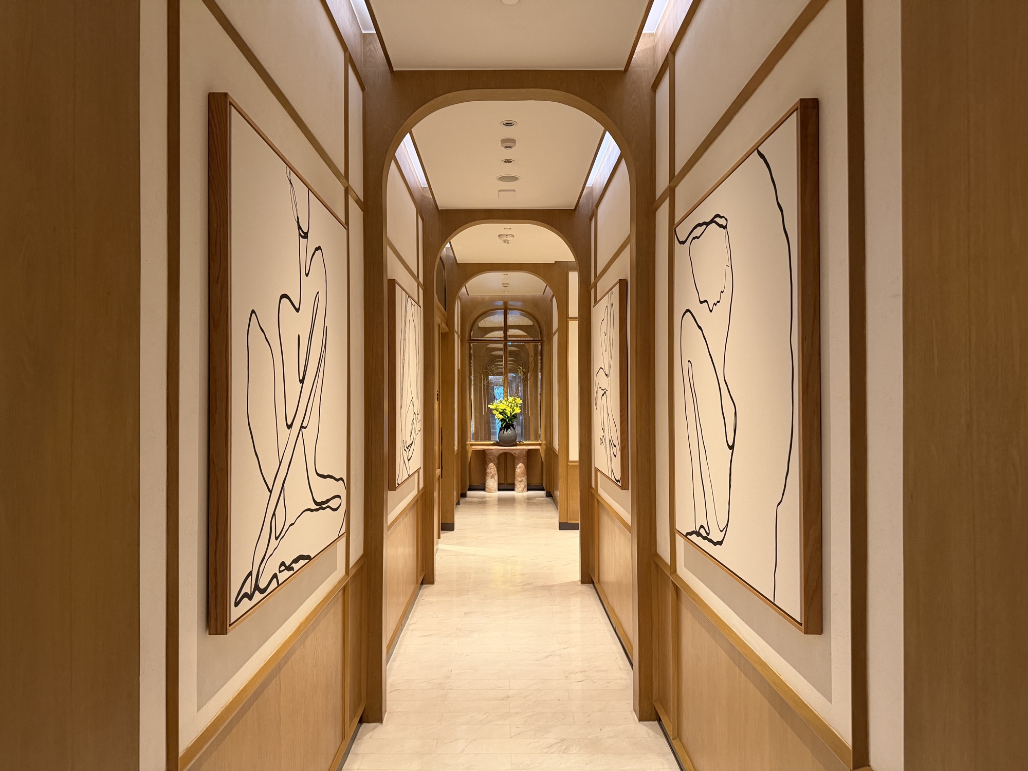 Arched corridors are hung with playful line art. at Four Seasons Hotel Bangkok at Chao Phraya River