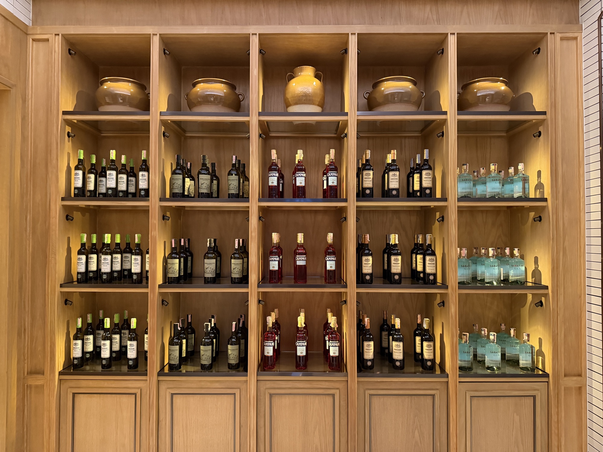 A wall of wine anchors one end of the room. at Four Seasons Hotel Bangkok at Chao Phraya River