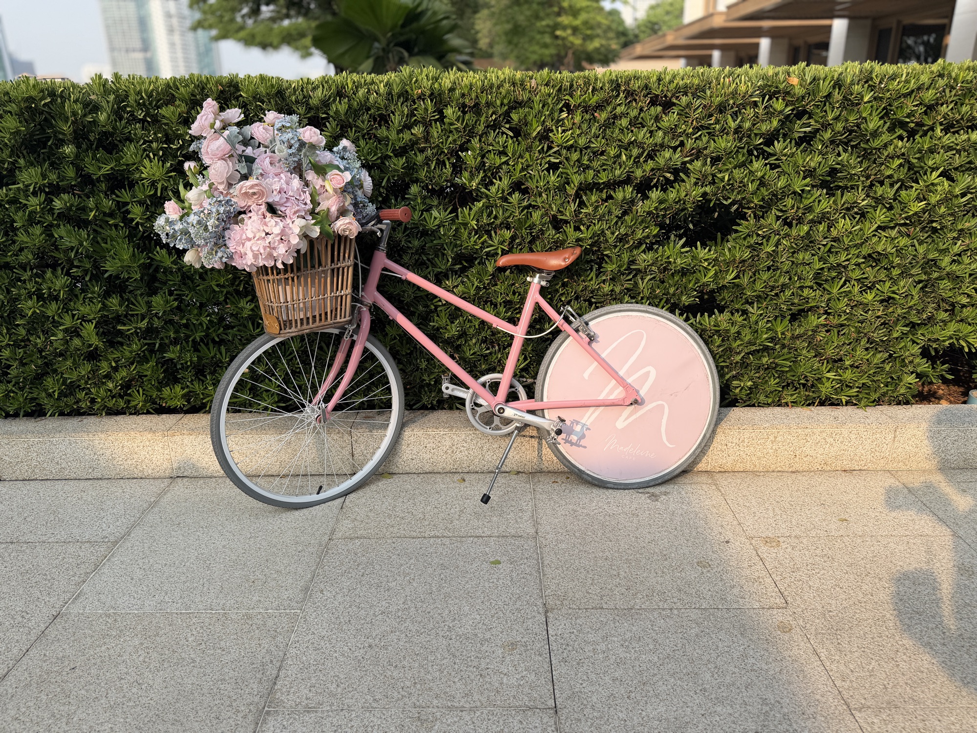 Pink bicycle with flower basket outside Café Madeleine at Four Seasons Hotel Bangkok at Chao Phraya River
