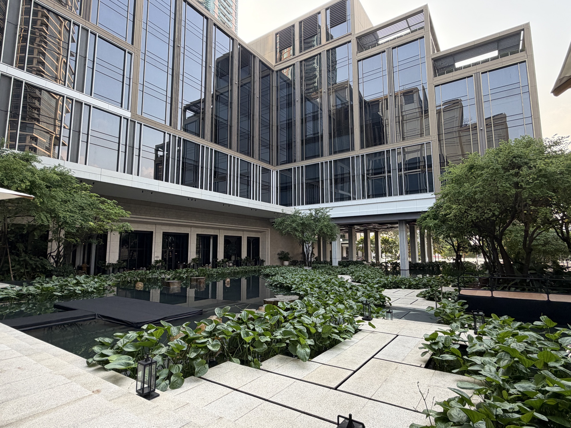 Courtyard lotus ponds between glass buildings at Four Seasons Hotel Bangkok at Chao Phraya River