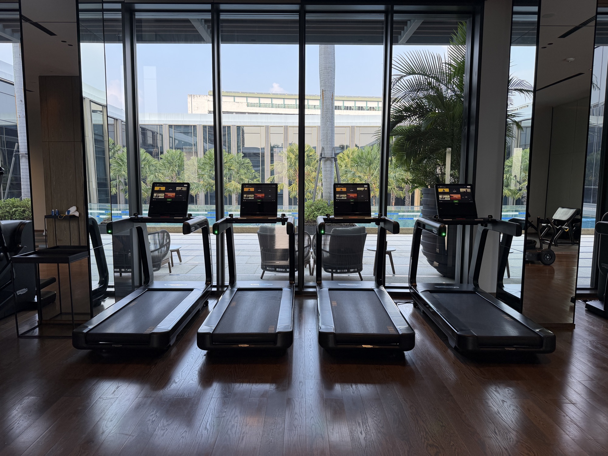 Treadmills facing the lap pool at the fitness centre at Four Seasons Hotel Bangkok at Chao Phraya River