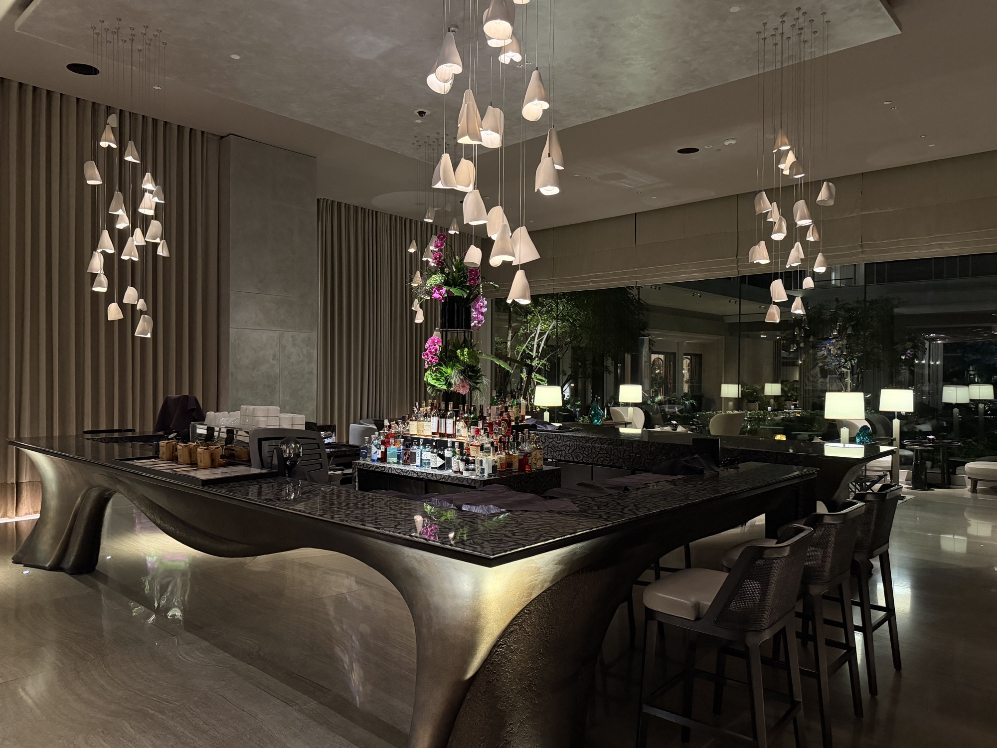 Sculptural lobby bar with pendant lights at Four Seasons Hotel Bangkok at Chao Phraya River