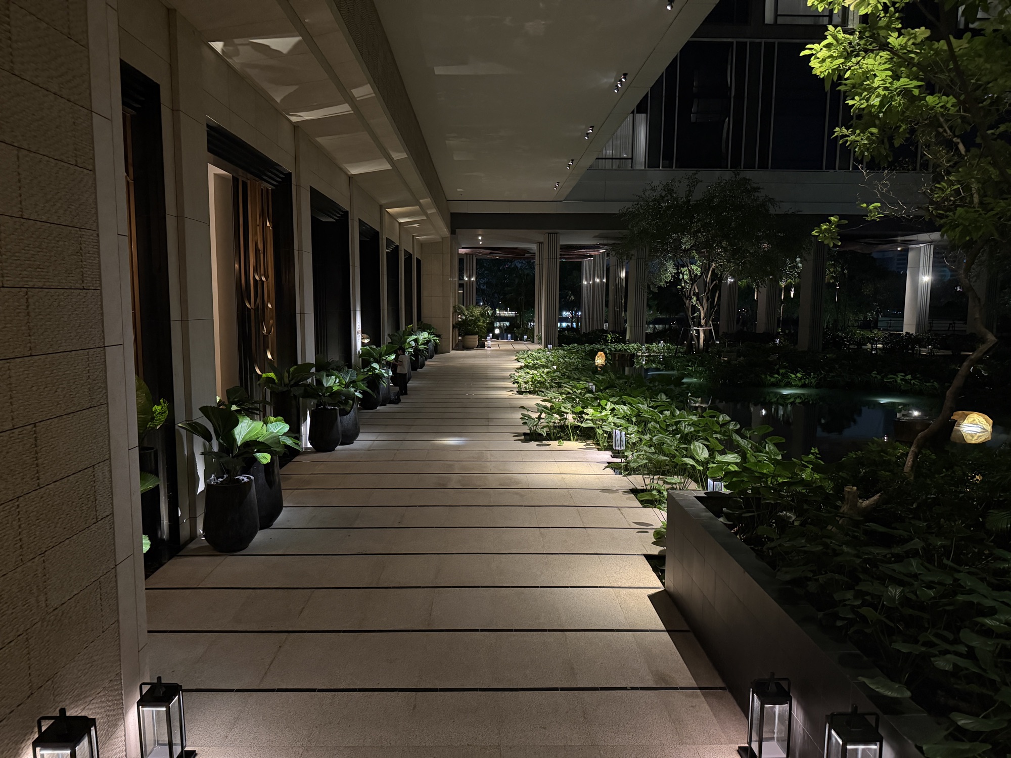 Lotus pond walkway lit at night at Four Seasons Hotel Bangkok at Chao Phraya River