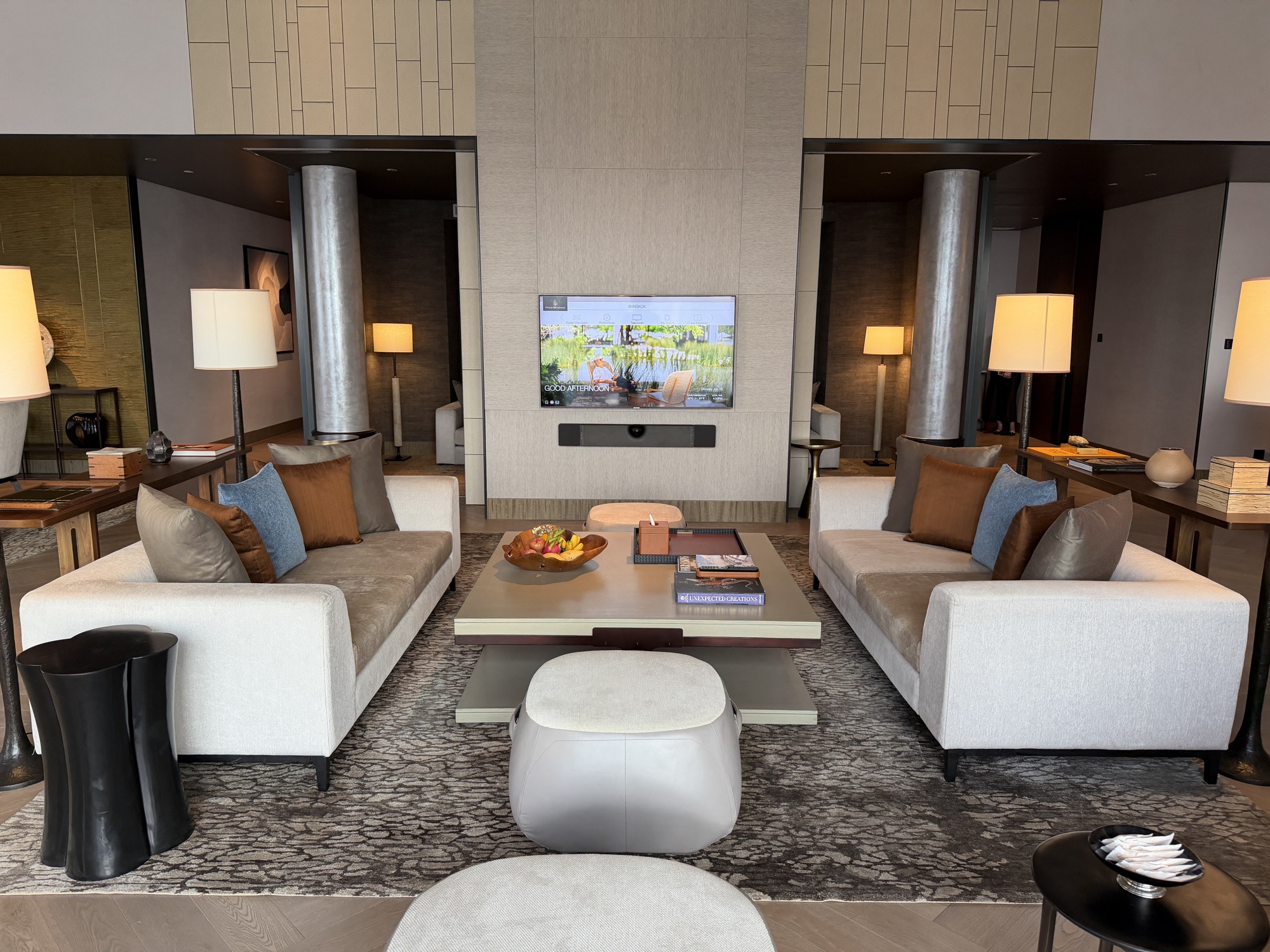 Facing sofas and media wall in the Riverfront Penthouse great room at Four Seasons Hotel Bangkok at Chao Phraya River