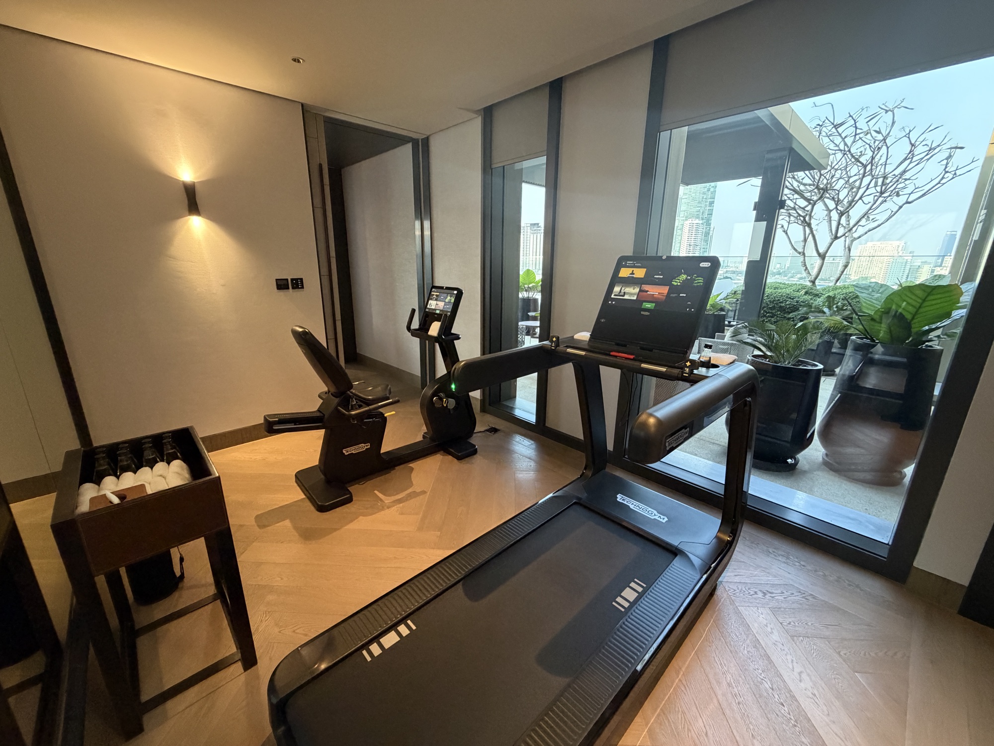 A treadmill and bike face the terrace. at Four Seasons Hotel Bangkok at Chao Phraya River