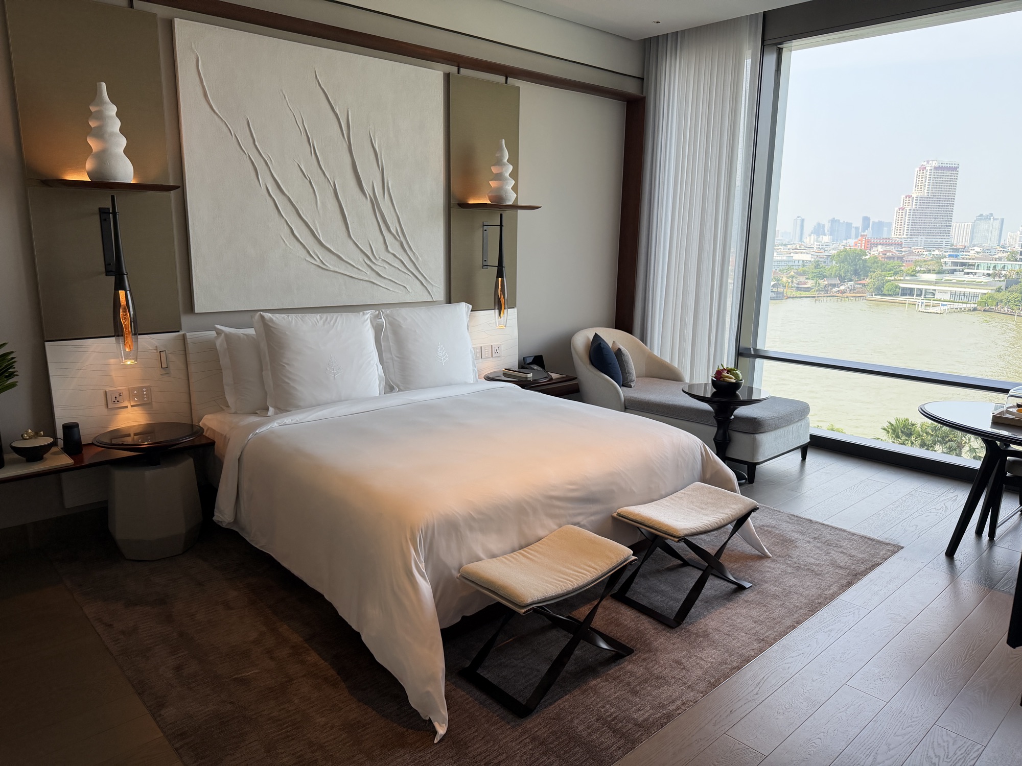 King bed with river view in the Deluxe River-View Room at Four Seasons Hotel Bangkok at Chao Phraya River
