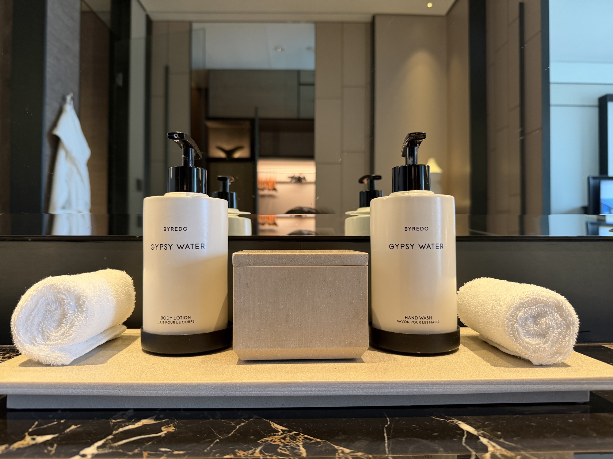 Full-size BYREDO Gypsy Water body lotion and hand wash on the bathroom vanity at Four Seasons Hotel Bangkok at Chao Phraya River