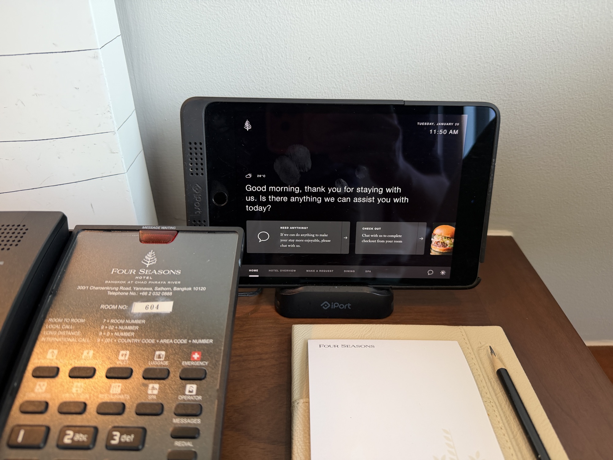 In-room control tablet and Four Seasons phone on the nightstand at Four Seasons Hotel Bangkok at Chao Phraya River