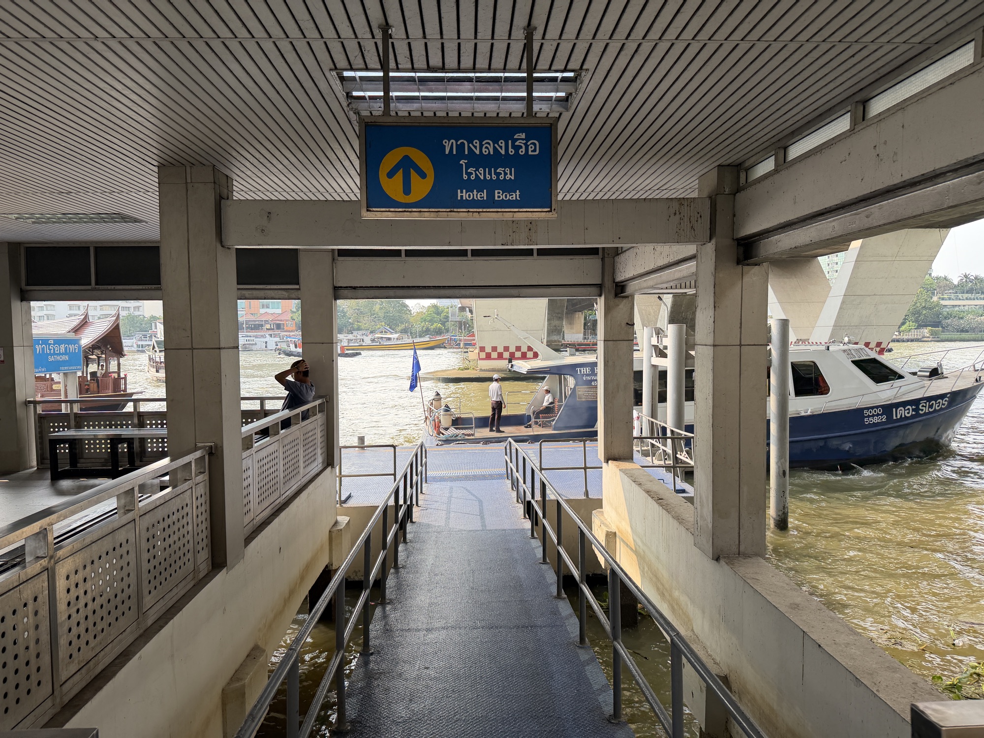 Hotel Boat sign and gangway down to the pier at Sathorn Pier for Four Seasons Hotel Bangkok at Chao Phraya River