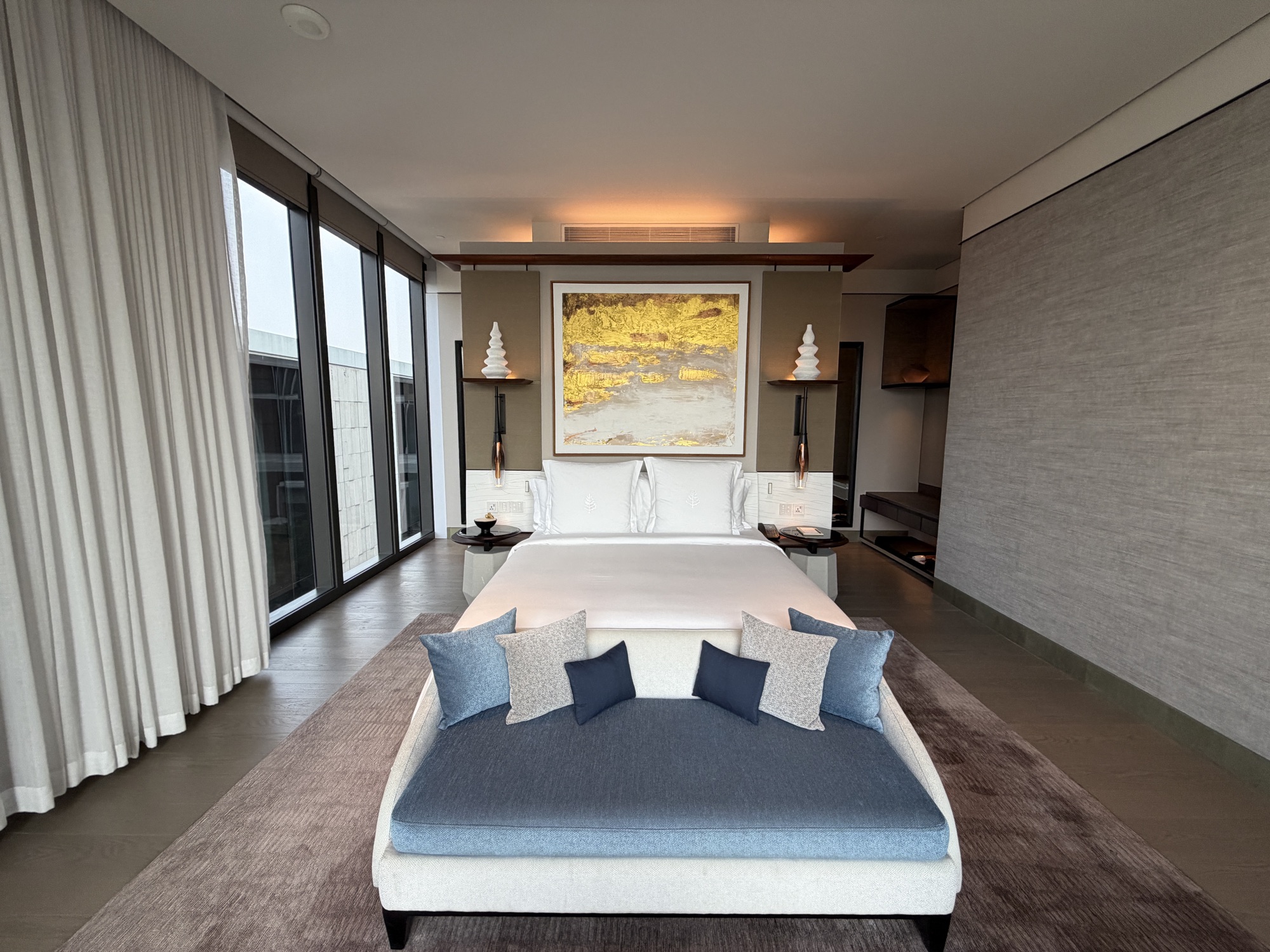 King bedroom with gold artwork in the Executive Suite at Four Seasons Hotel Bangkok at Chao Phraya River