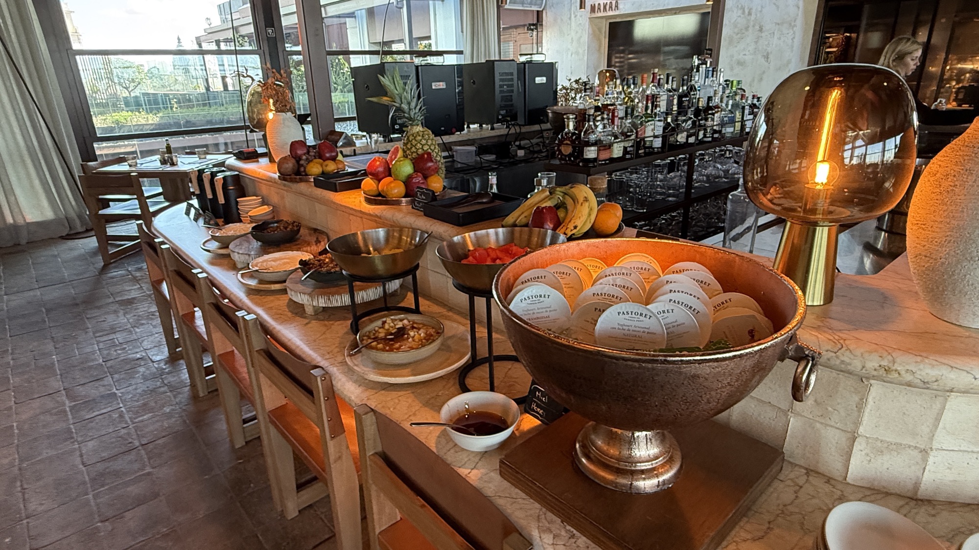 Continental breakfast buffet with breads, fruit, and pastries