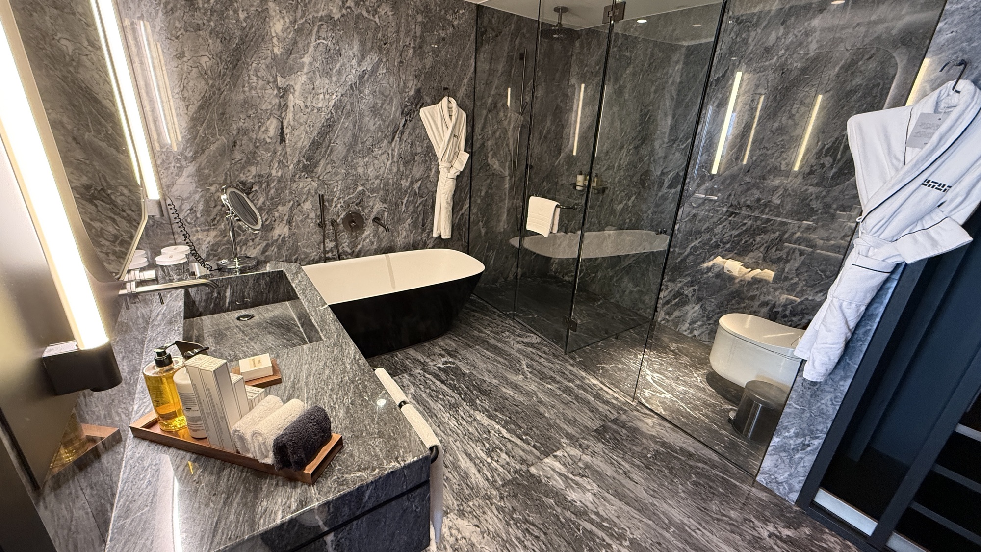 Junior Suite marble bathroom with a freestanding soaking tub and walk-in shower