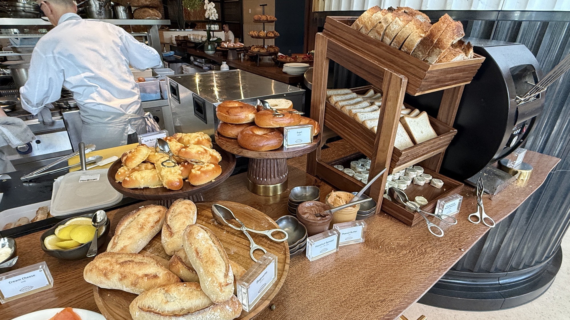Bakery station with fresh breads, scones, and viennoiserie at breakfast