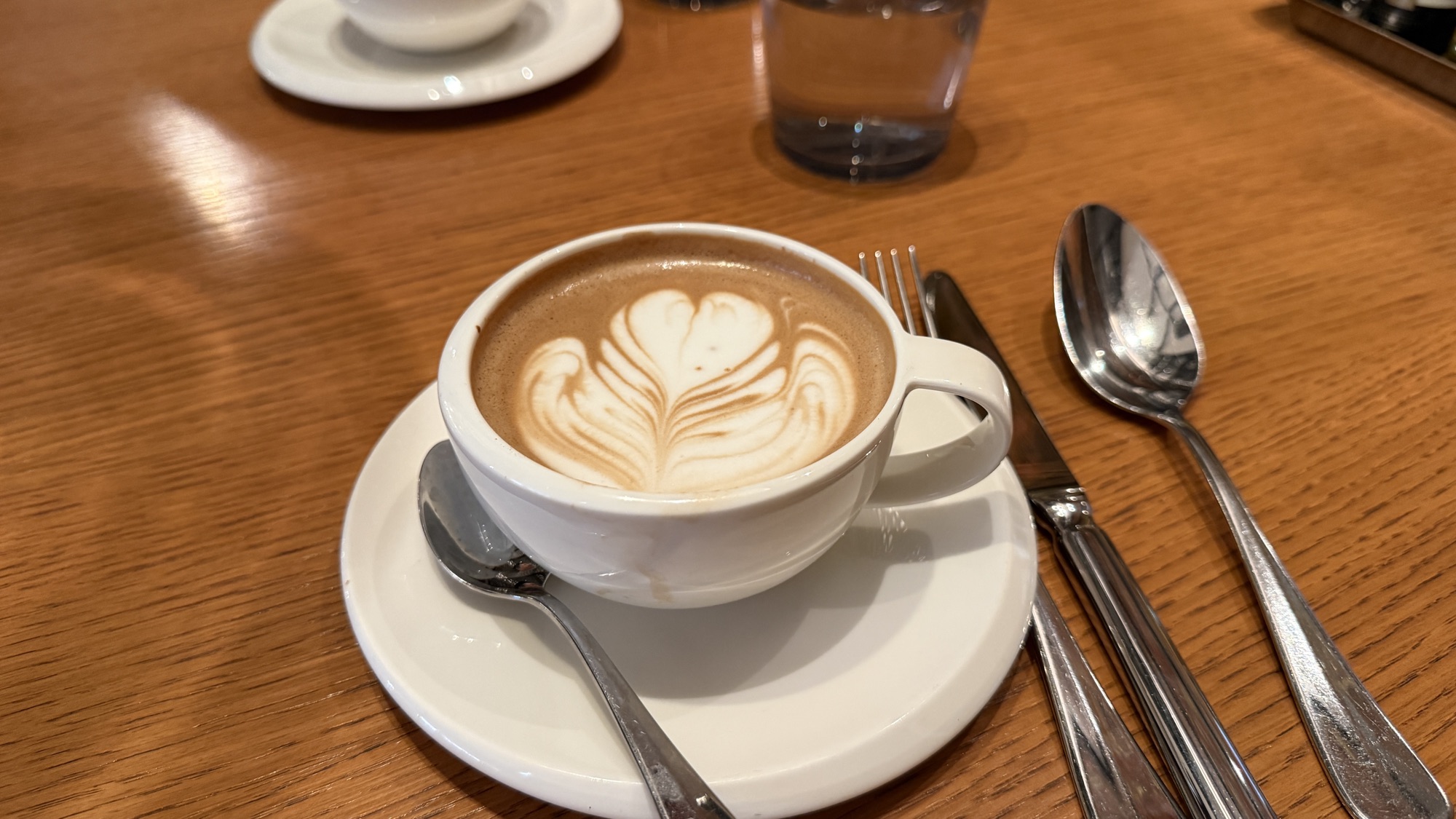 Flat white coffee with latte art at breakfast