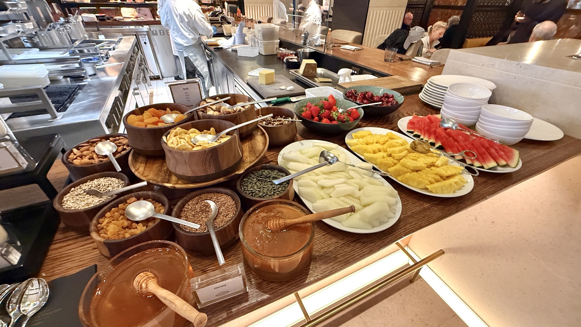 Fresh fruit, granola jars, honey, and preserves on the breakfast buffet