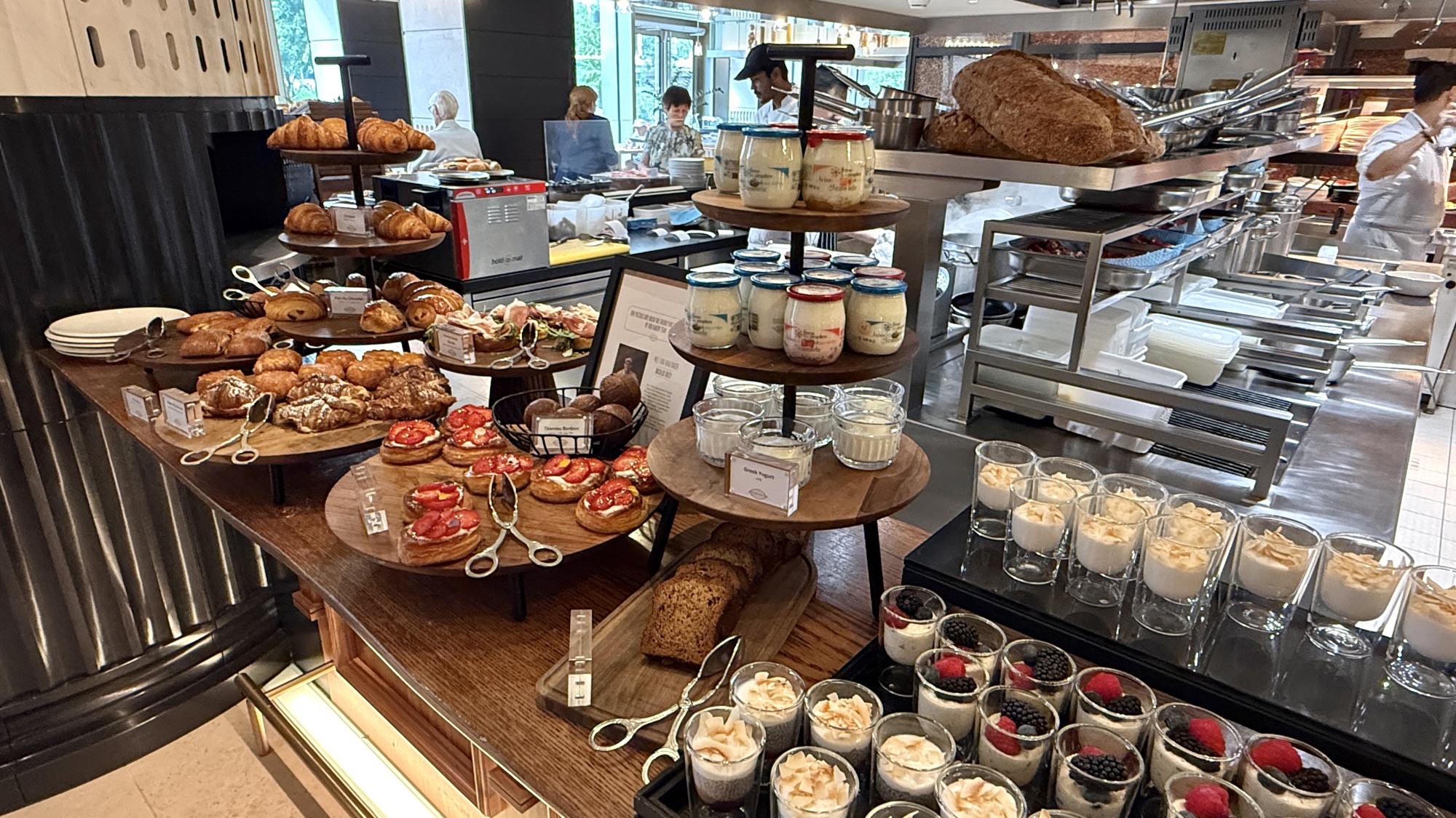 Tiered stand of pastries, tarts, and yoghurt jars at the Nine Elms Kitchen breakfast buffet
