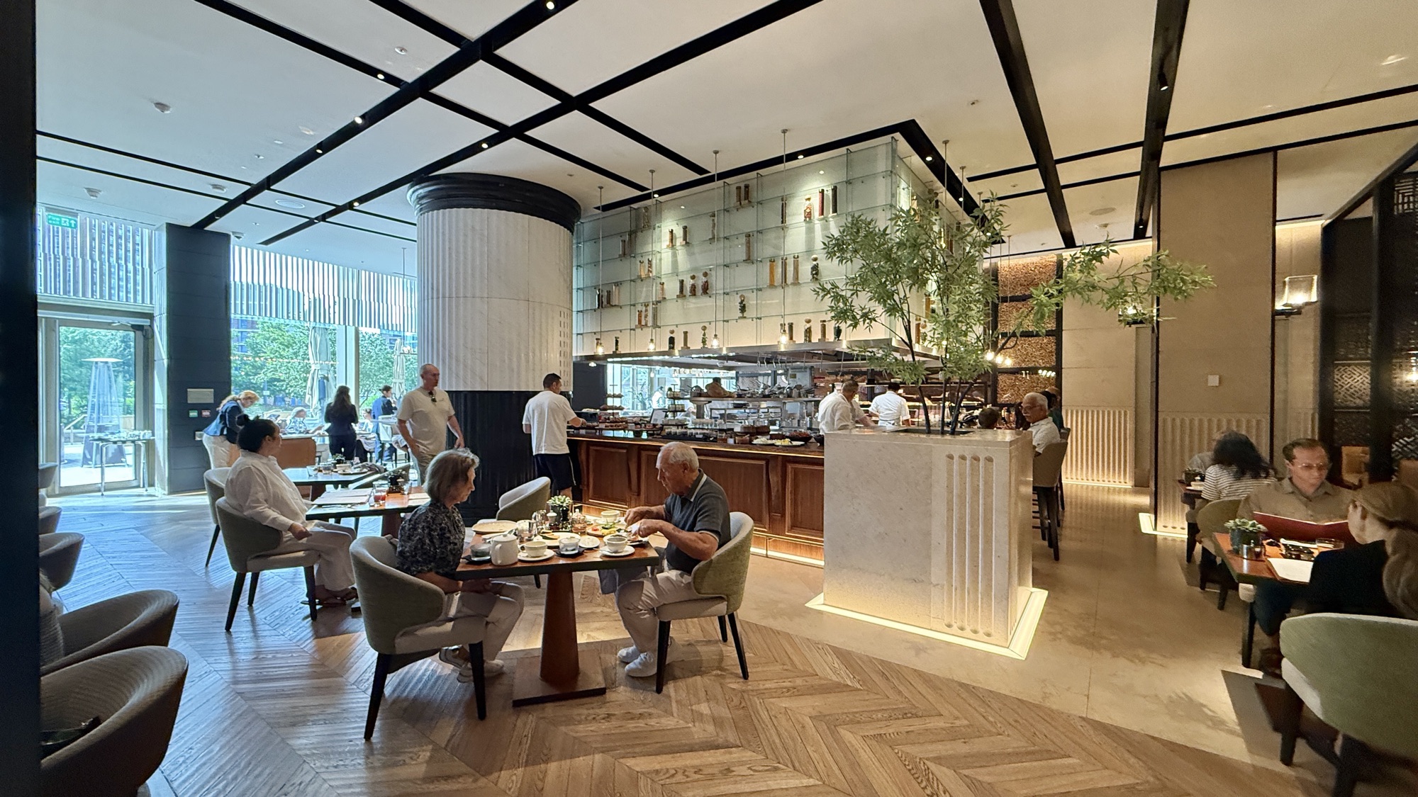 Dining room at Nine Elms Kitchen with herringbone floors and guests seated for breakfast