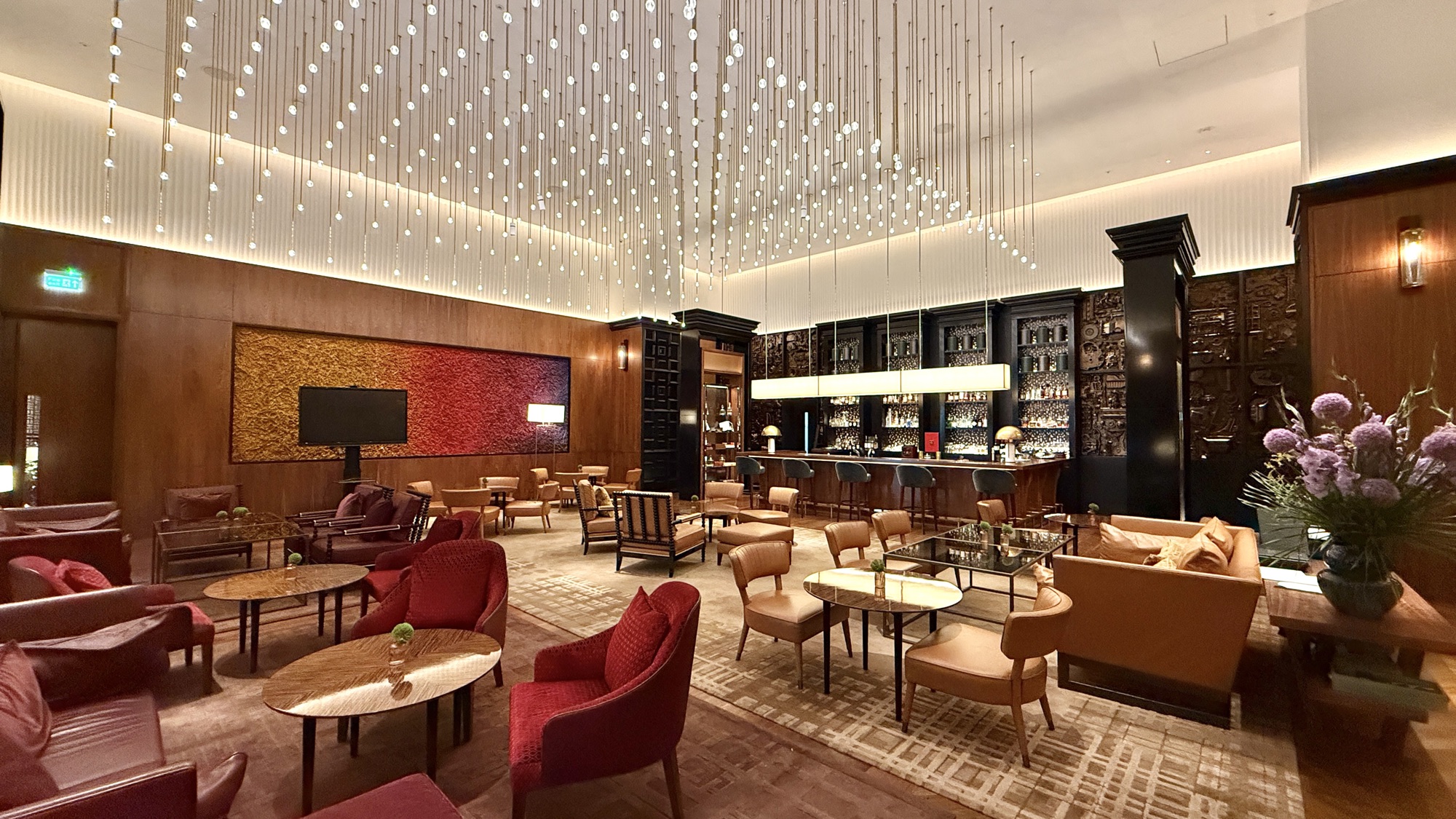 Interior of the Nine Elms Lounge and Bar with armchairs, a bar, and a starlit ceiling
