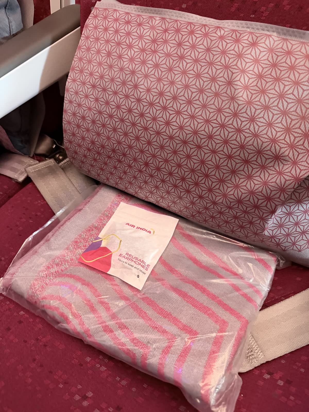 Economy pillow and packaged blanket in a pink geometric pattern