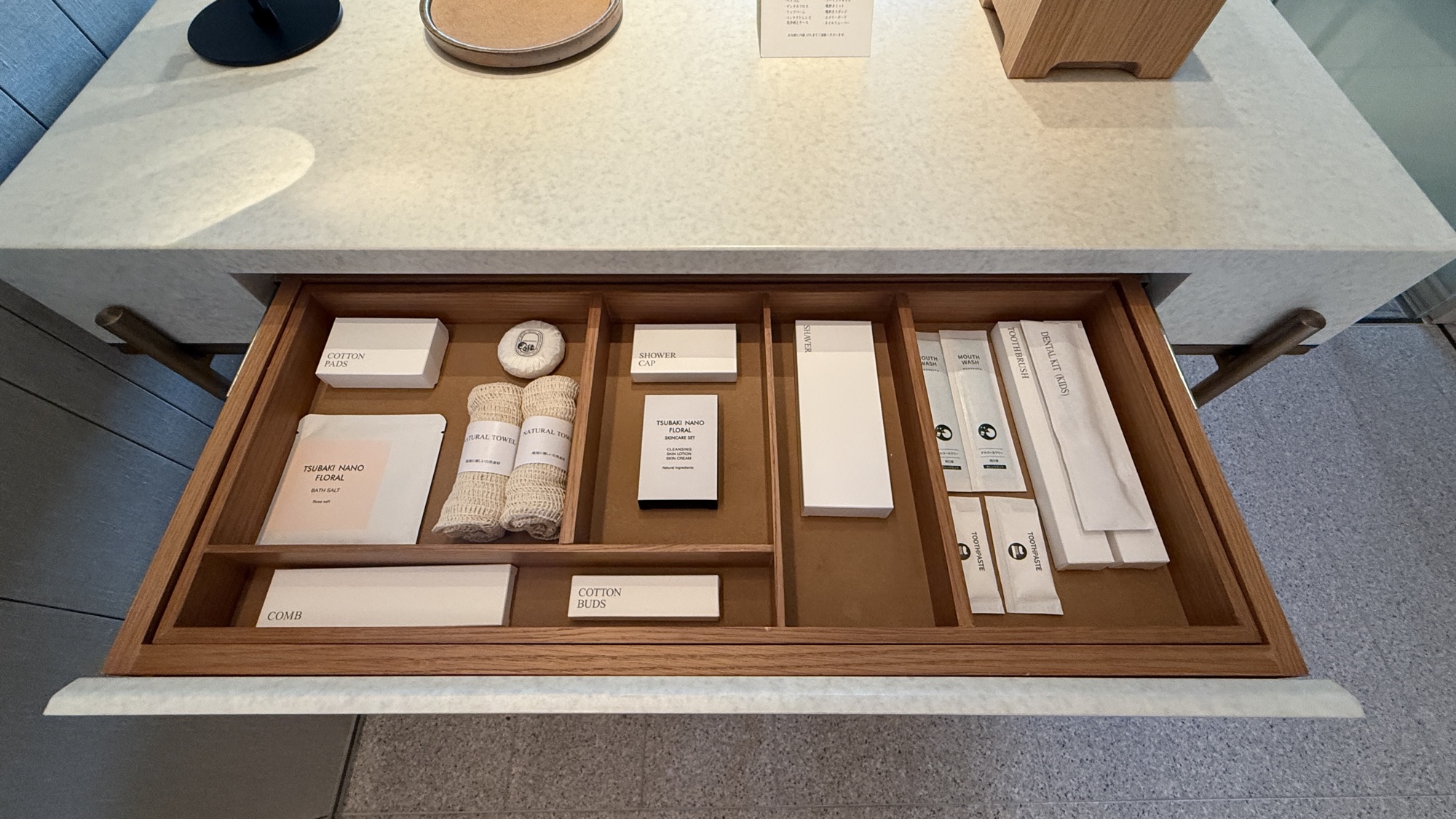 Open drawer of neatly arranged toiletries and amenities