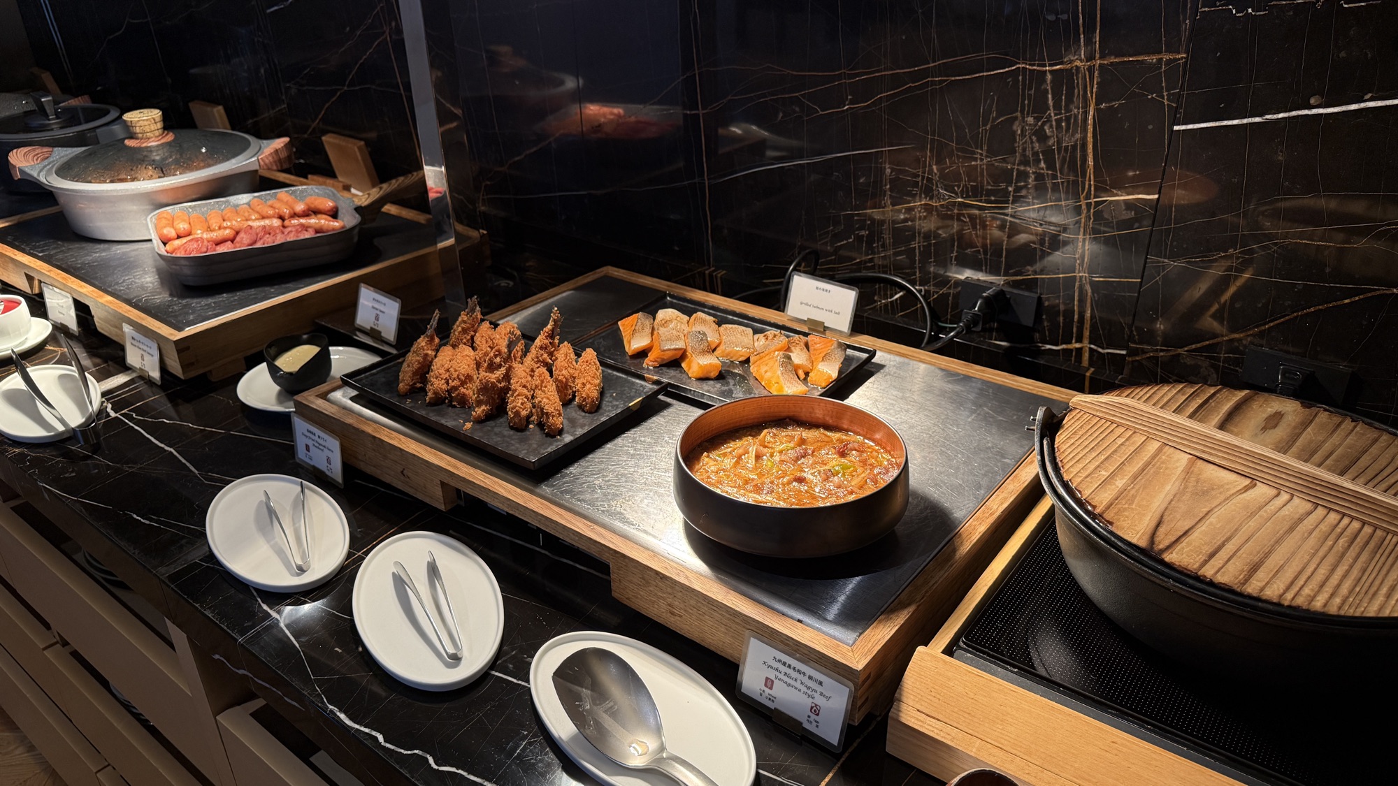 Hot breakfast dishes including smoked salmon and fried items