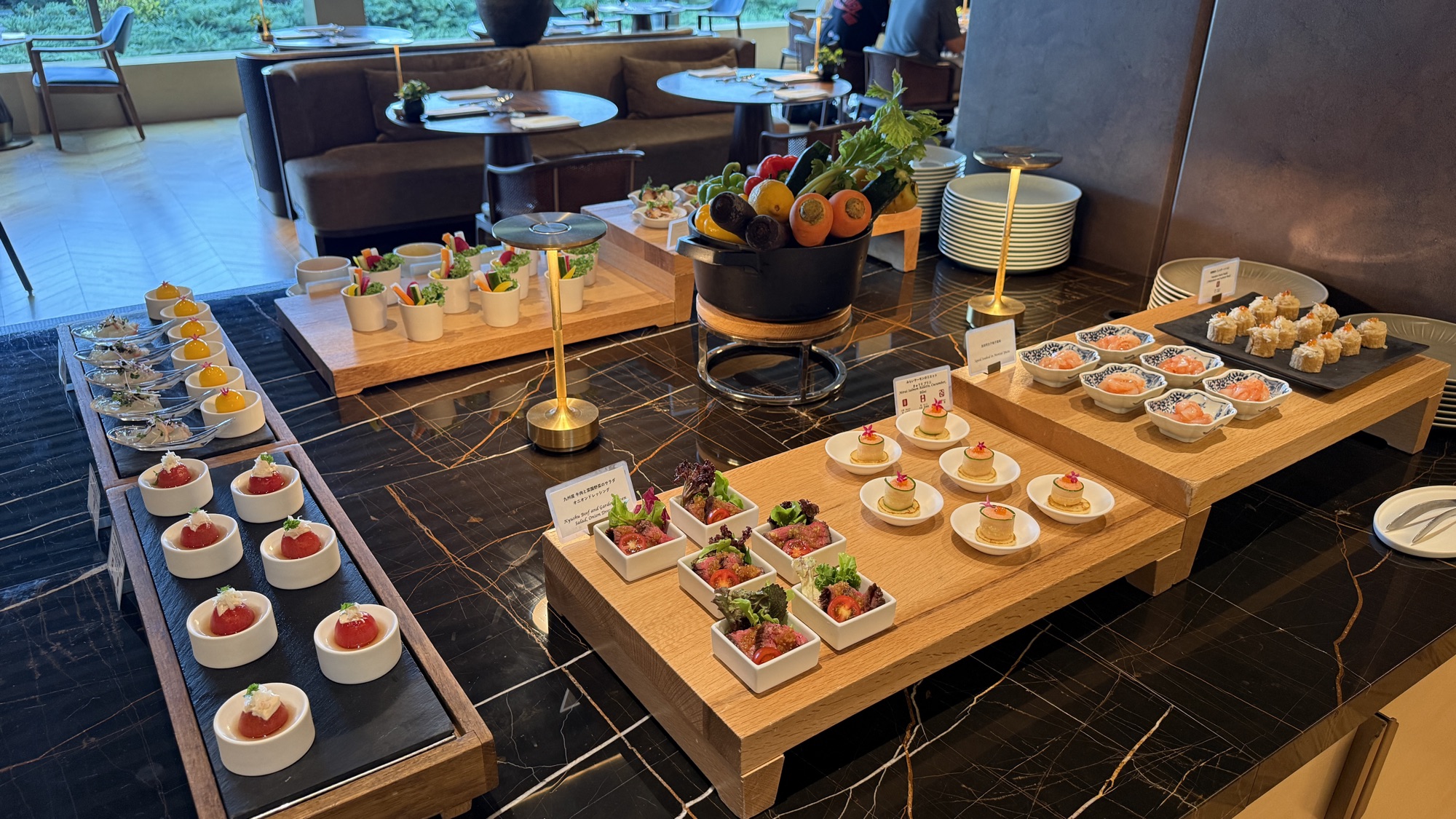 Rows of canapes and verrines on wooden boards