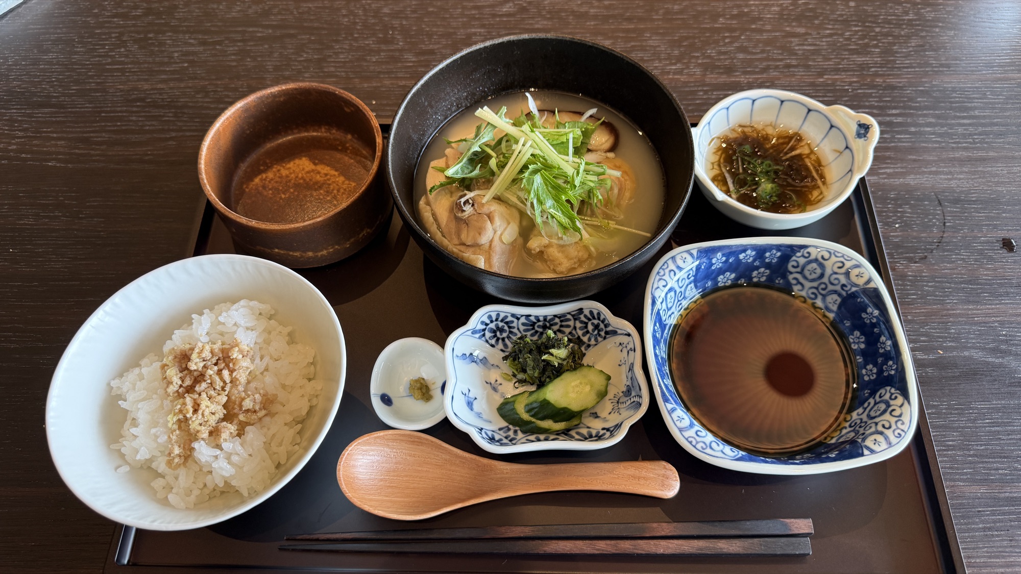 The chicken hot pot set with rice, pickles and side dishes
