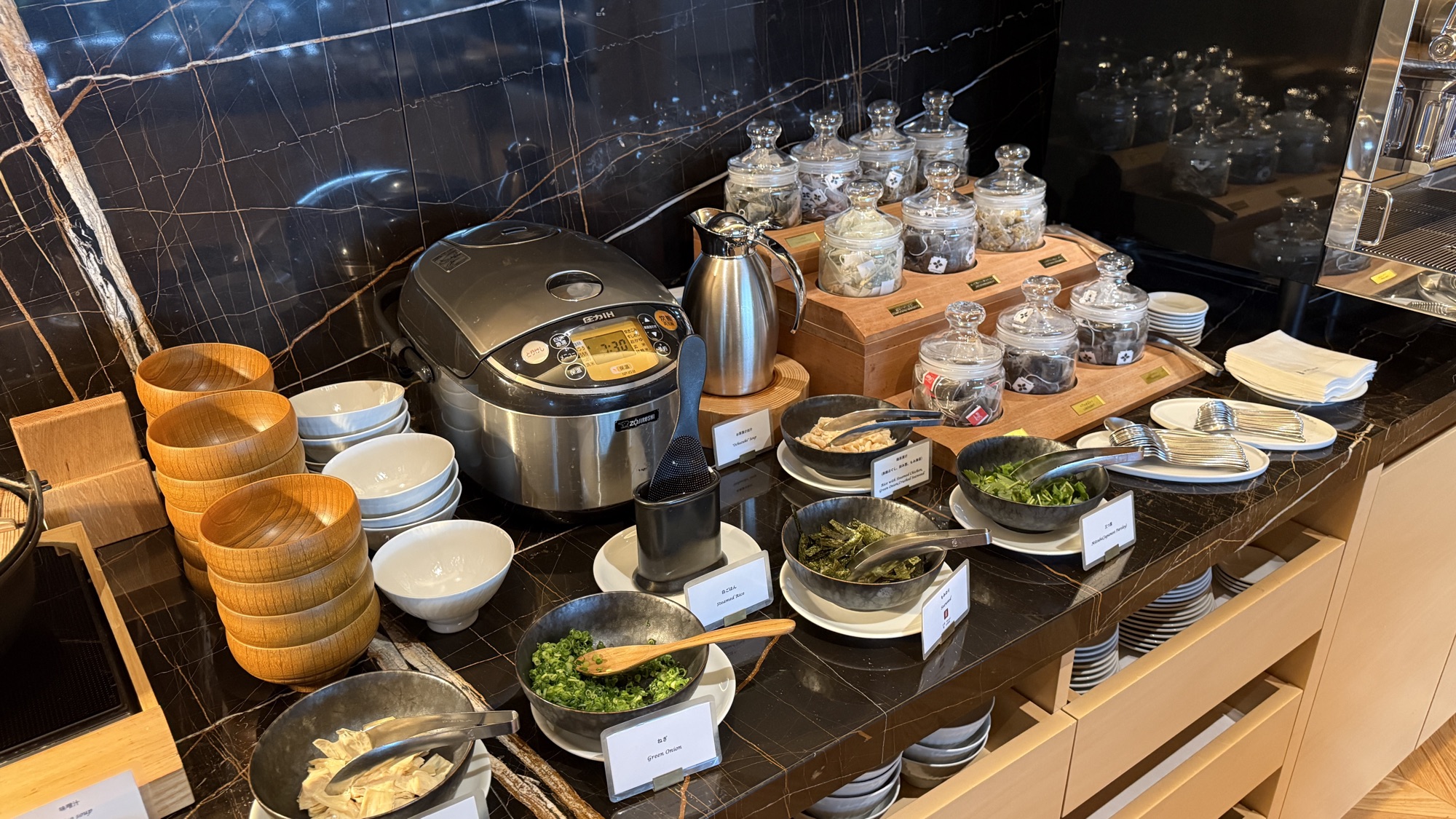 Japanese breakfast station with rice, condiments and small bowls