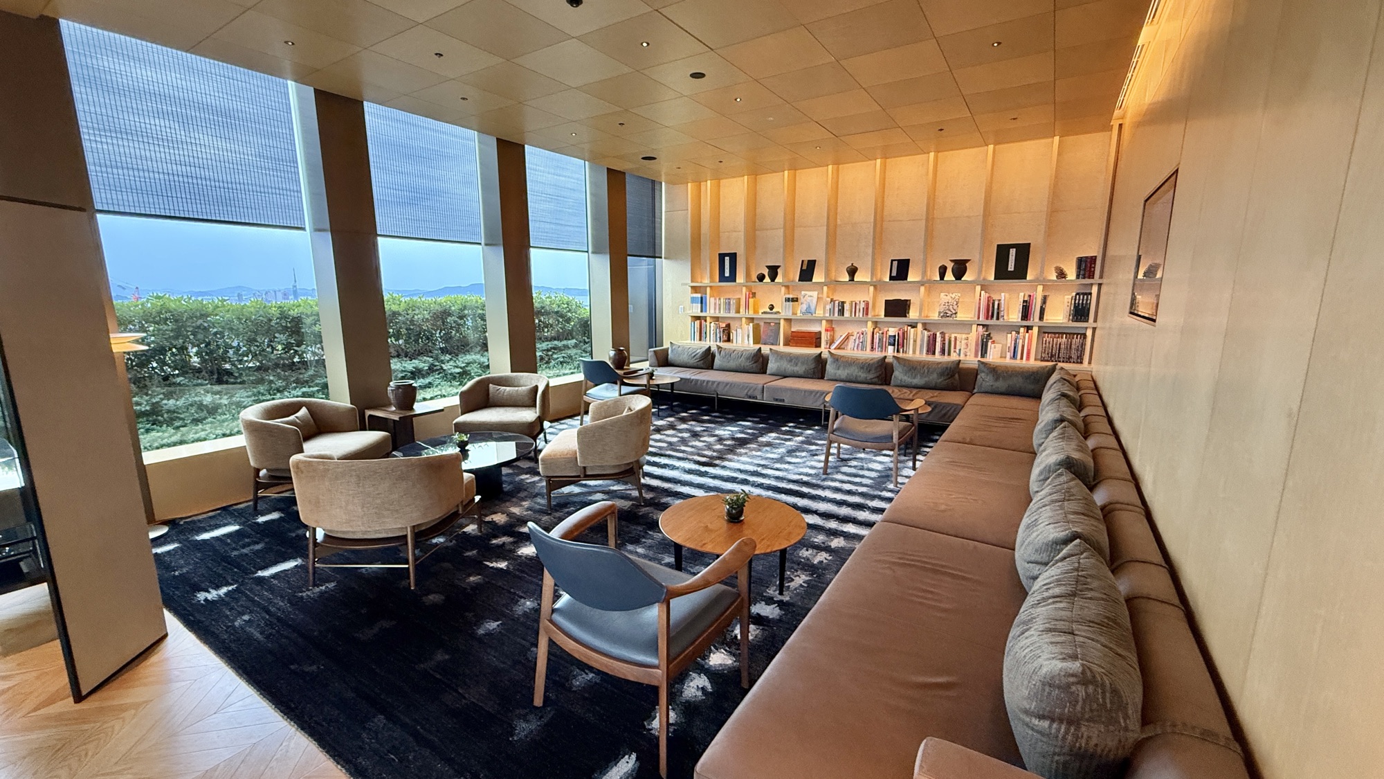 Library corner of the Club Lounge with bookshelves and a long banquette