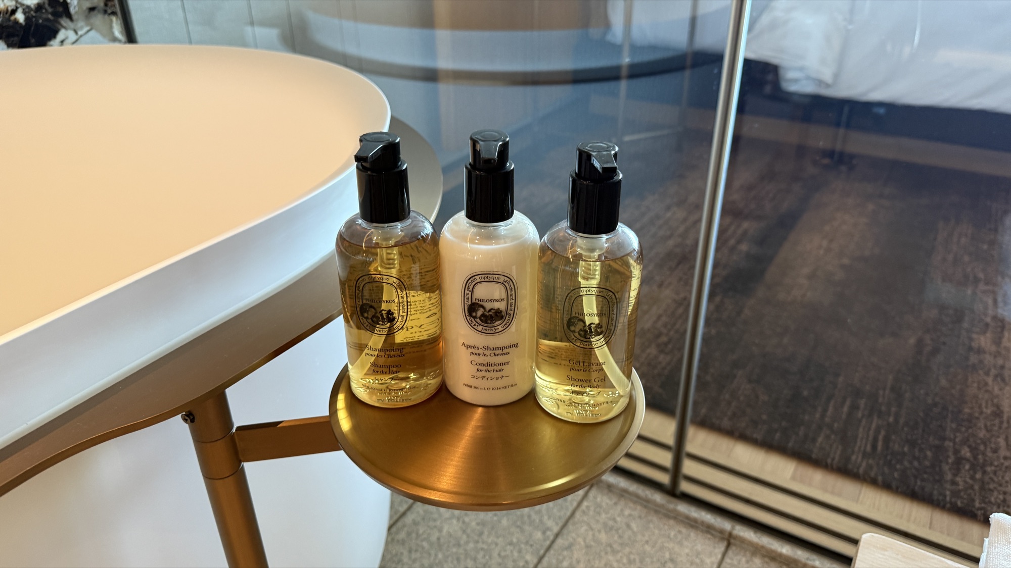 Diptyque bathroom amenities on a brass tray