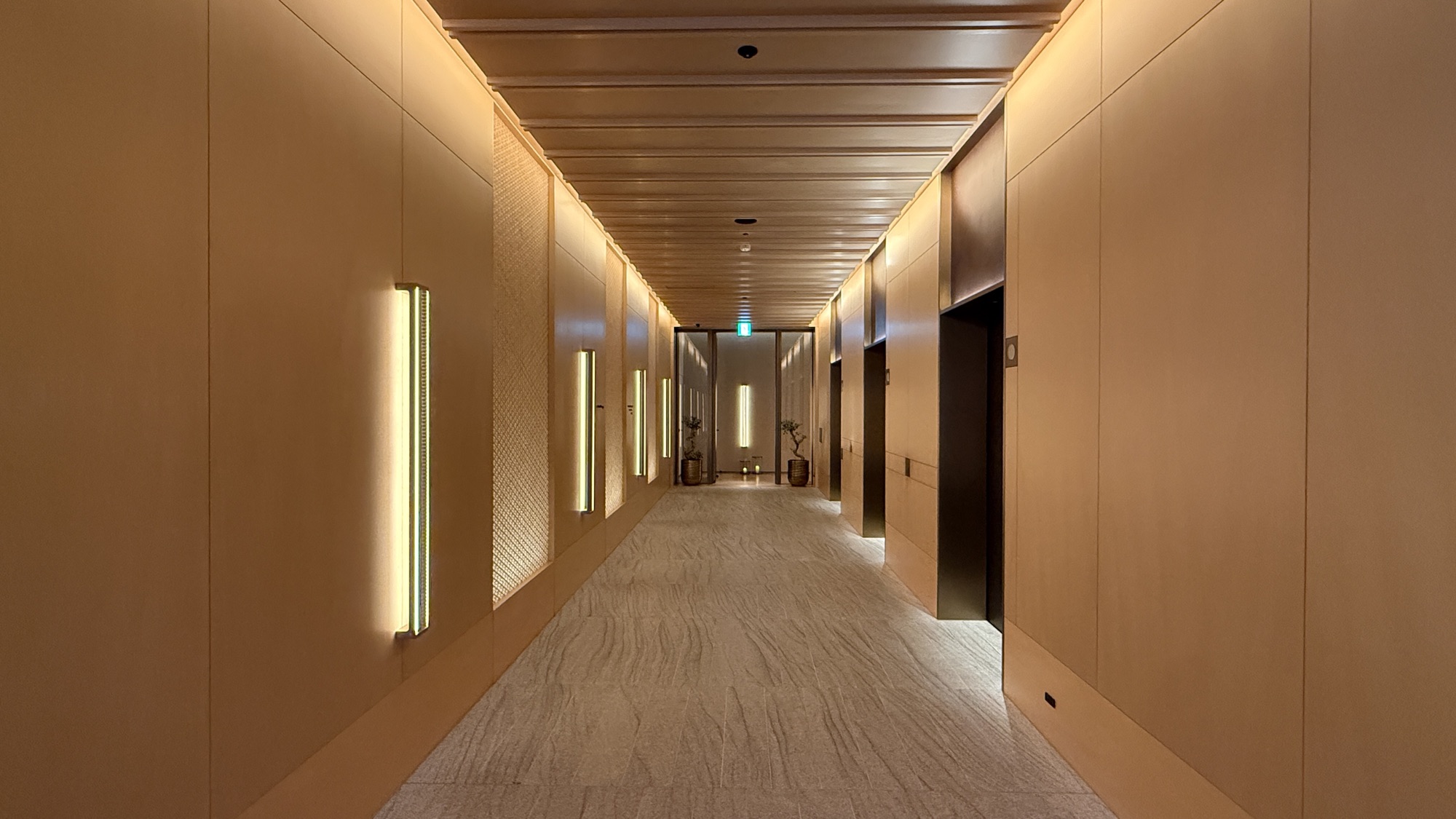 Warmly lit corridor leading to the spa and fitness floor
