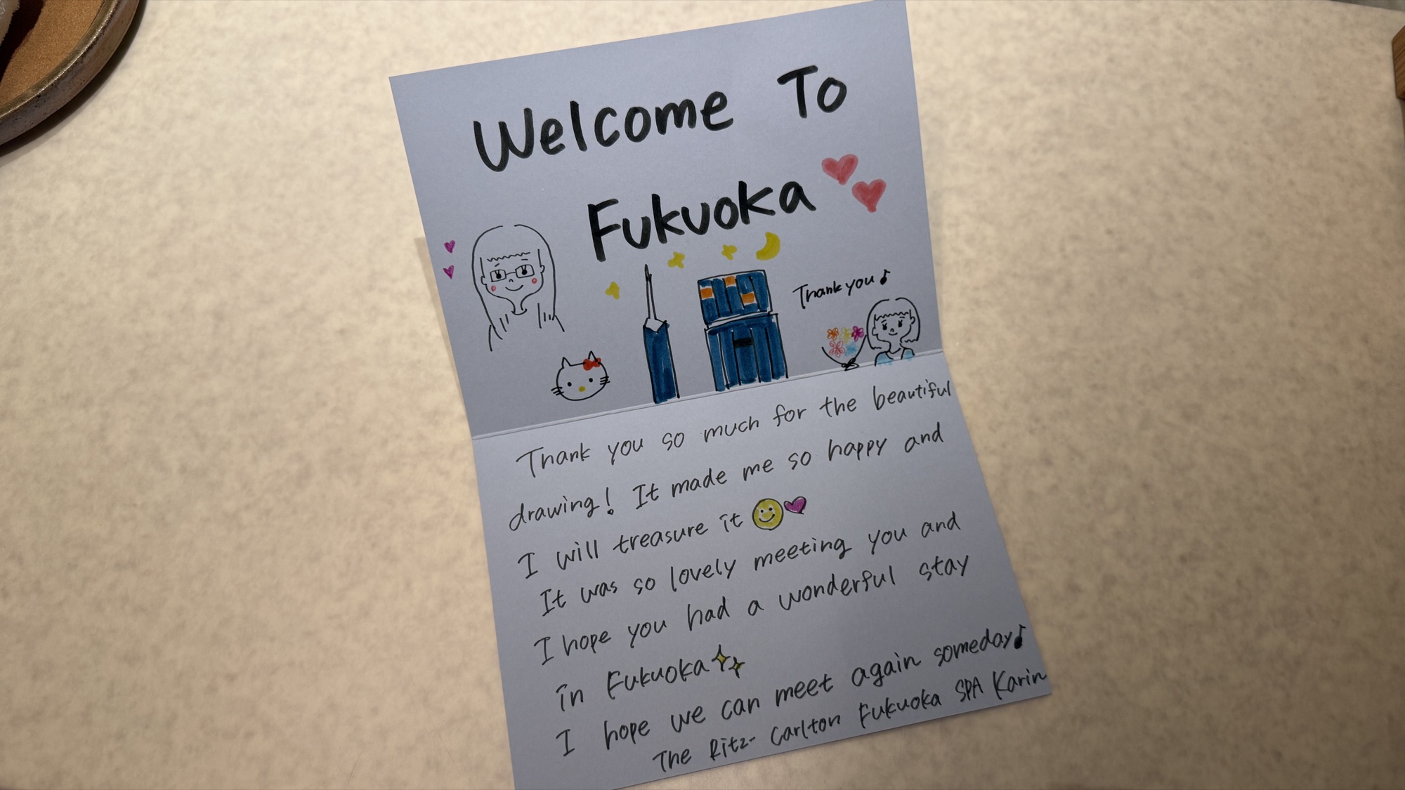 A handwritten card from the spa team thanking the author's daughter for her drawing