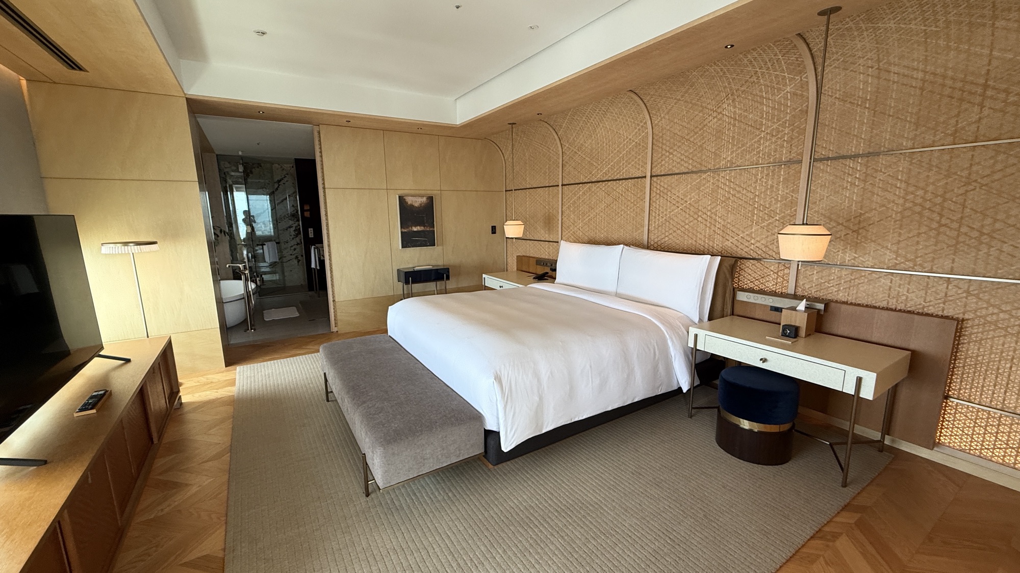 Bedroom of the Ritz-Carlton Suite with woven wall panelling