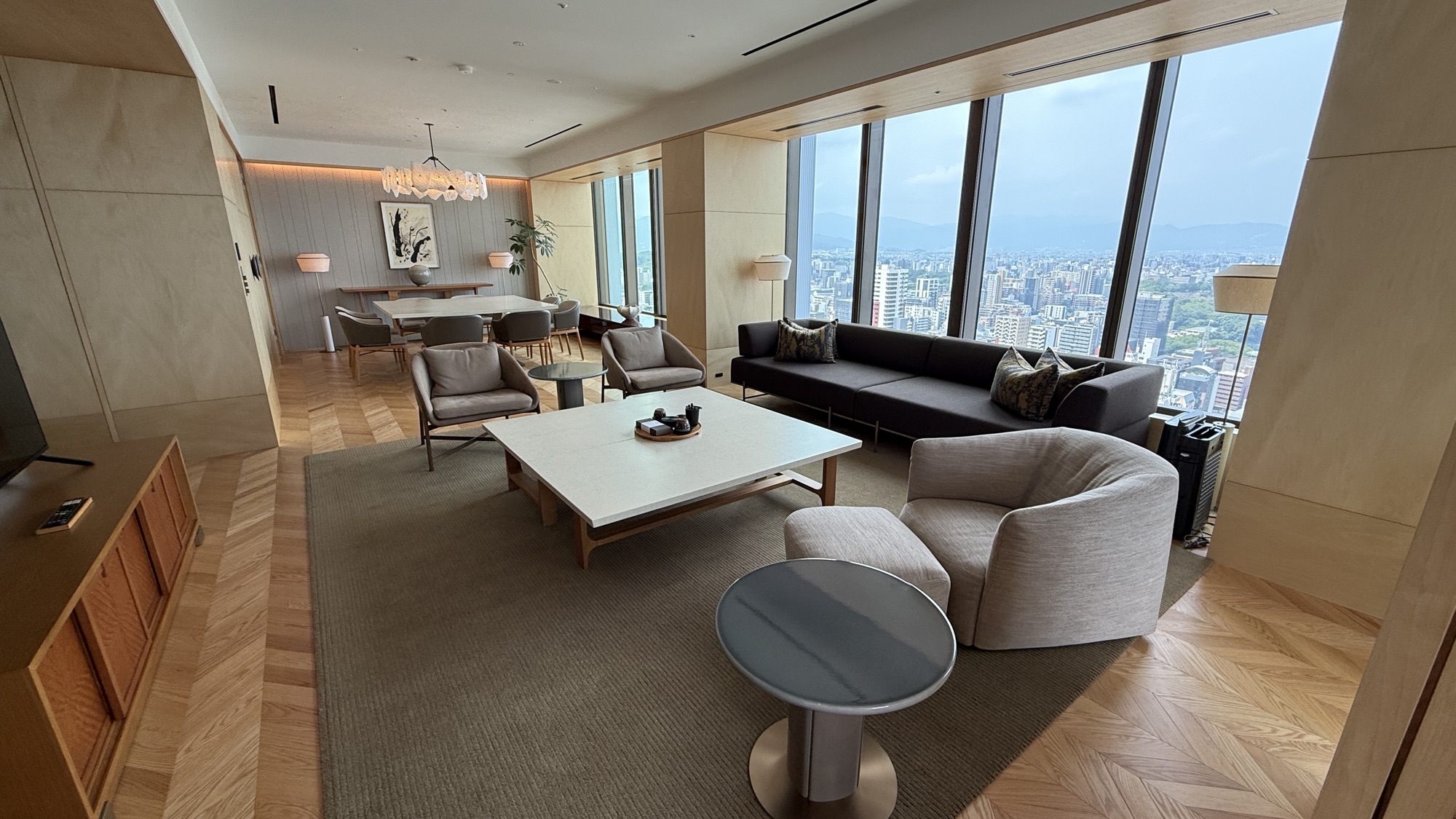 Living room of the Ritz-Carlton Suite with city views and a long sofa