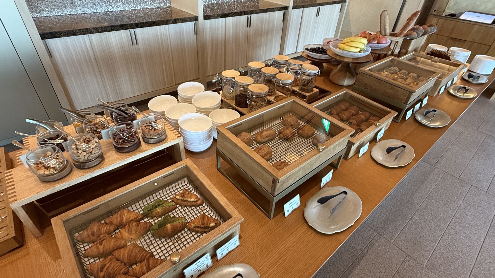 Bakery station with pastries and breads in wooden boxes