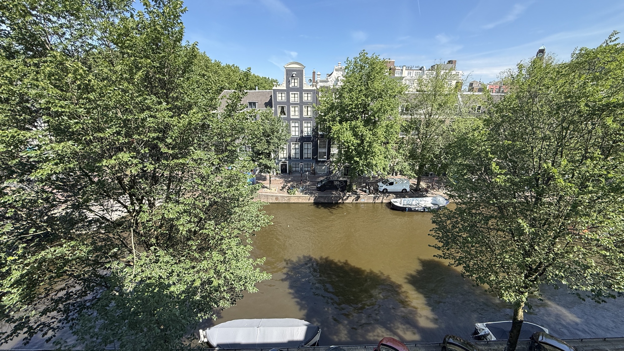 View of the tree-lined canal and boats from the King Grand Premier with Canal View room