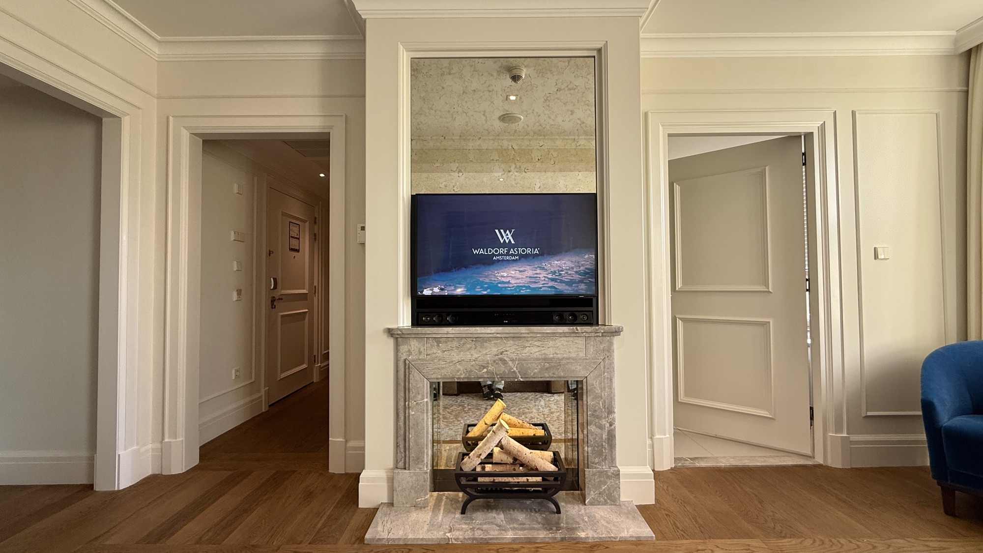 Decorative fireplace with a Waldorf Astoria screen above it in the King Grand Premier room