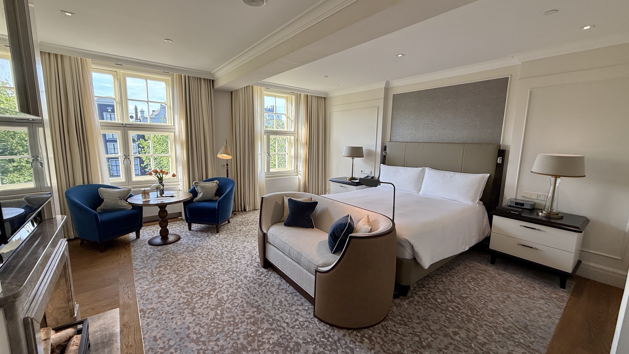King Grand Premier with Canal View room with a king bed, seating area, and windows overlooking the canal