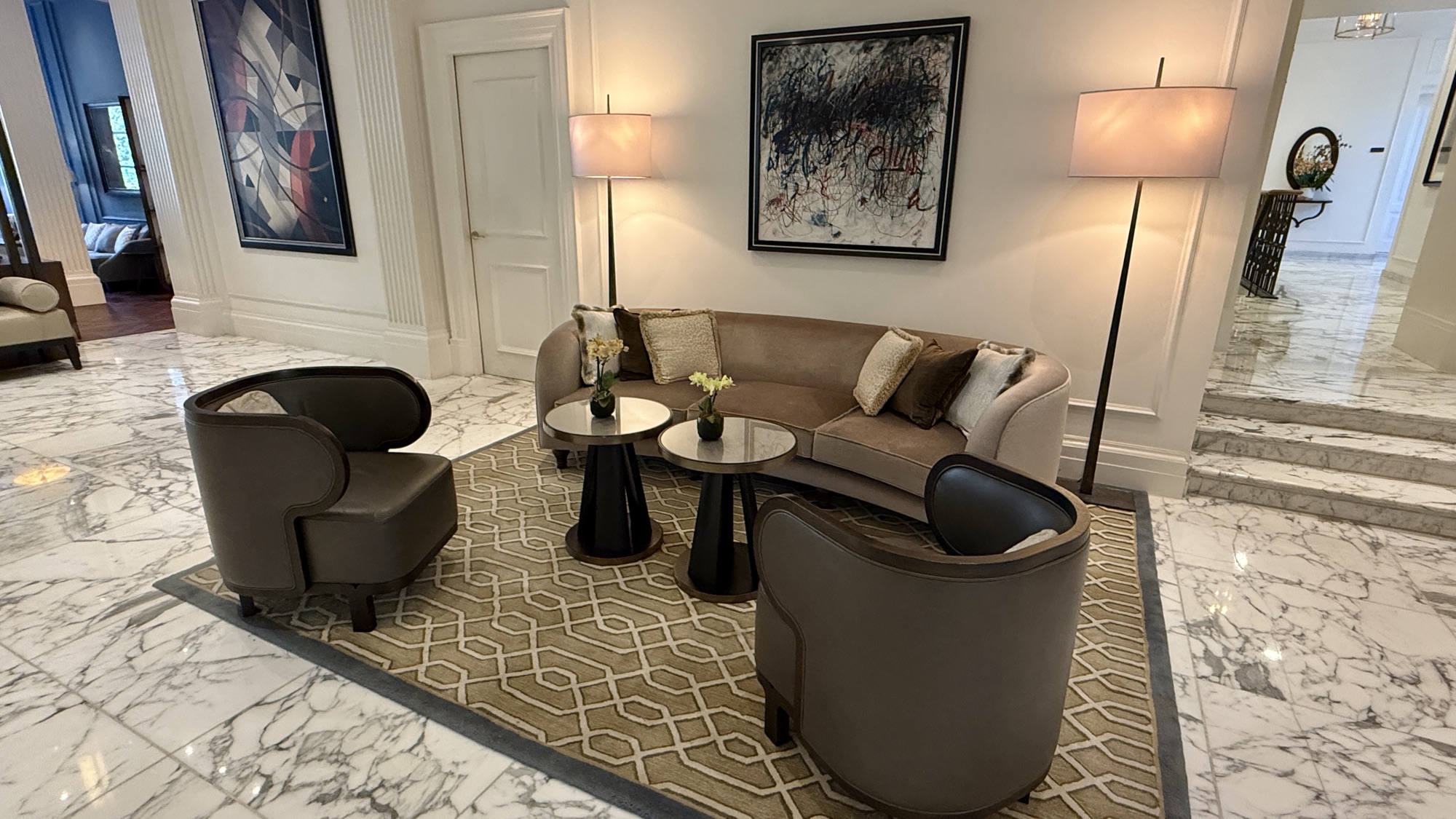 Lobby lounge in the evening with armchairs and a statement chandelier