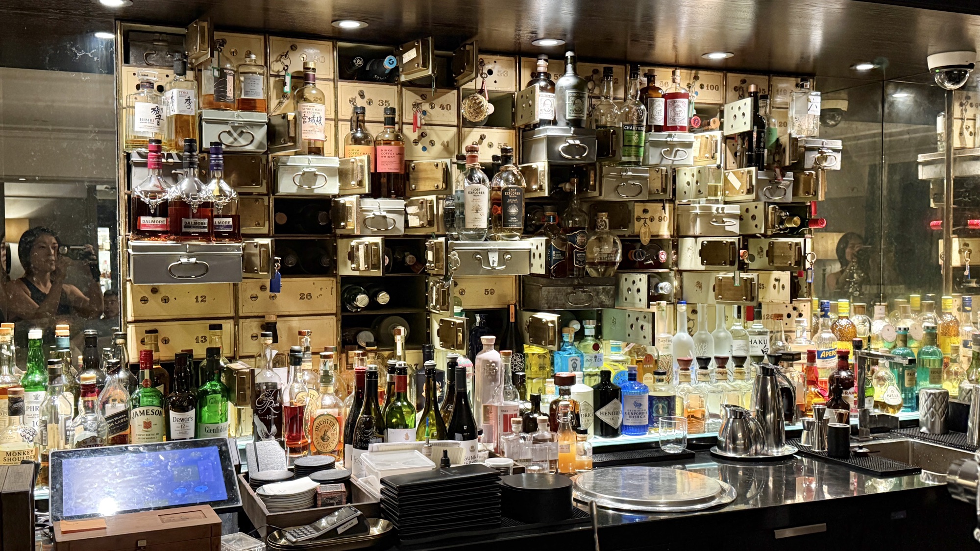 Spirits displayed in the former safe-deposit boxes behind the Vault Bar